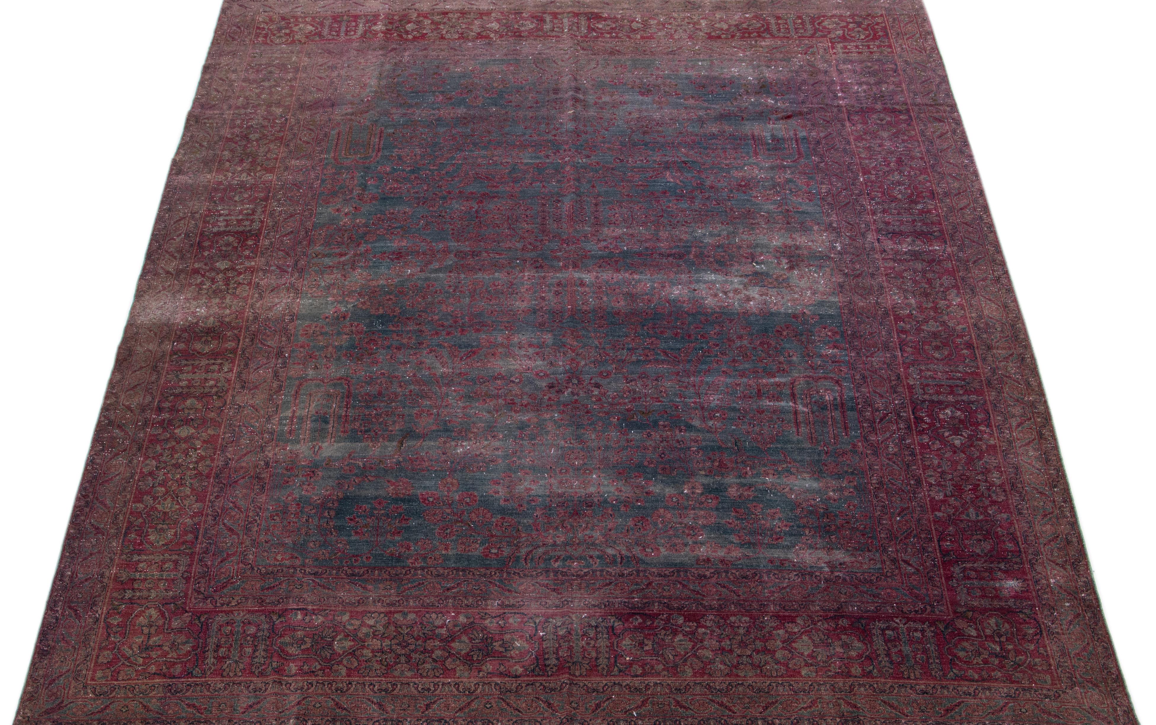 Beautiful antique Persian distressed hand-knotted wool rug with a gray color field. This piece has red accents in a gorgeous all-over floral design.

This rug measures: 8'10' x 11'6