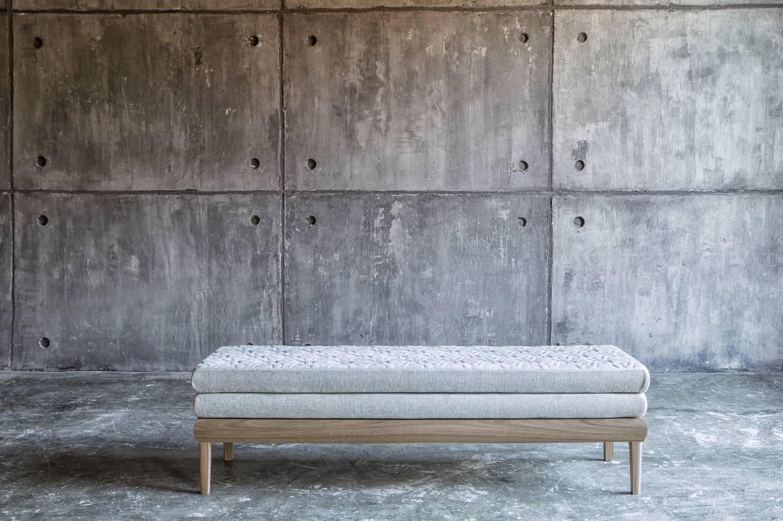 An elegant seating option that suits modern and traditional settings alike, this bench frame is made of Canaletto walnut with straight legs and a solid base that give it an architectural aesthetic. The rectangular cushions are upholstered in a