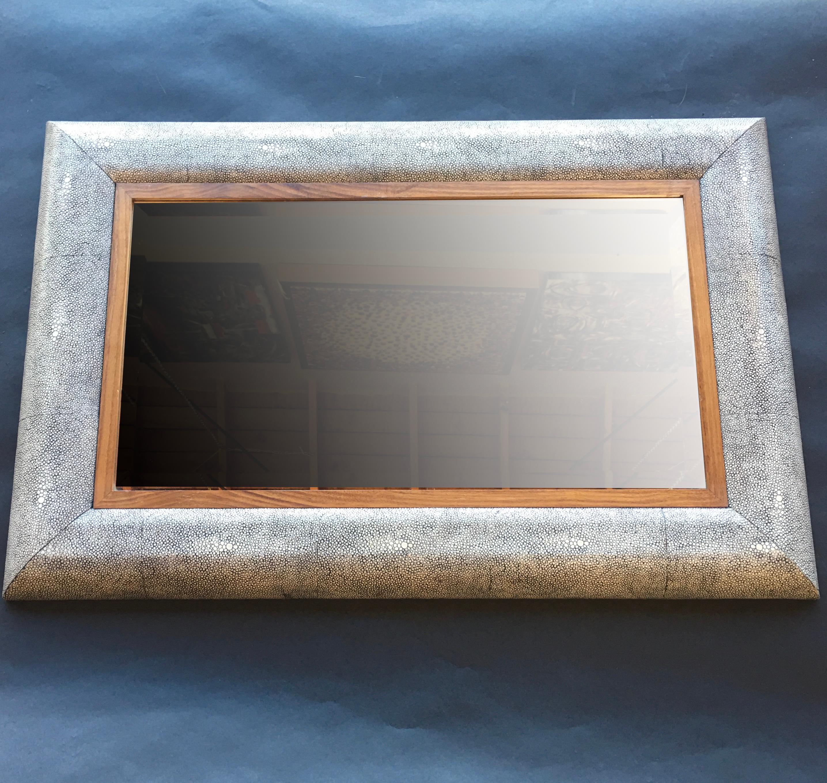 Gray shagreen mirror with wood inner frame and bevel.
