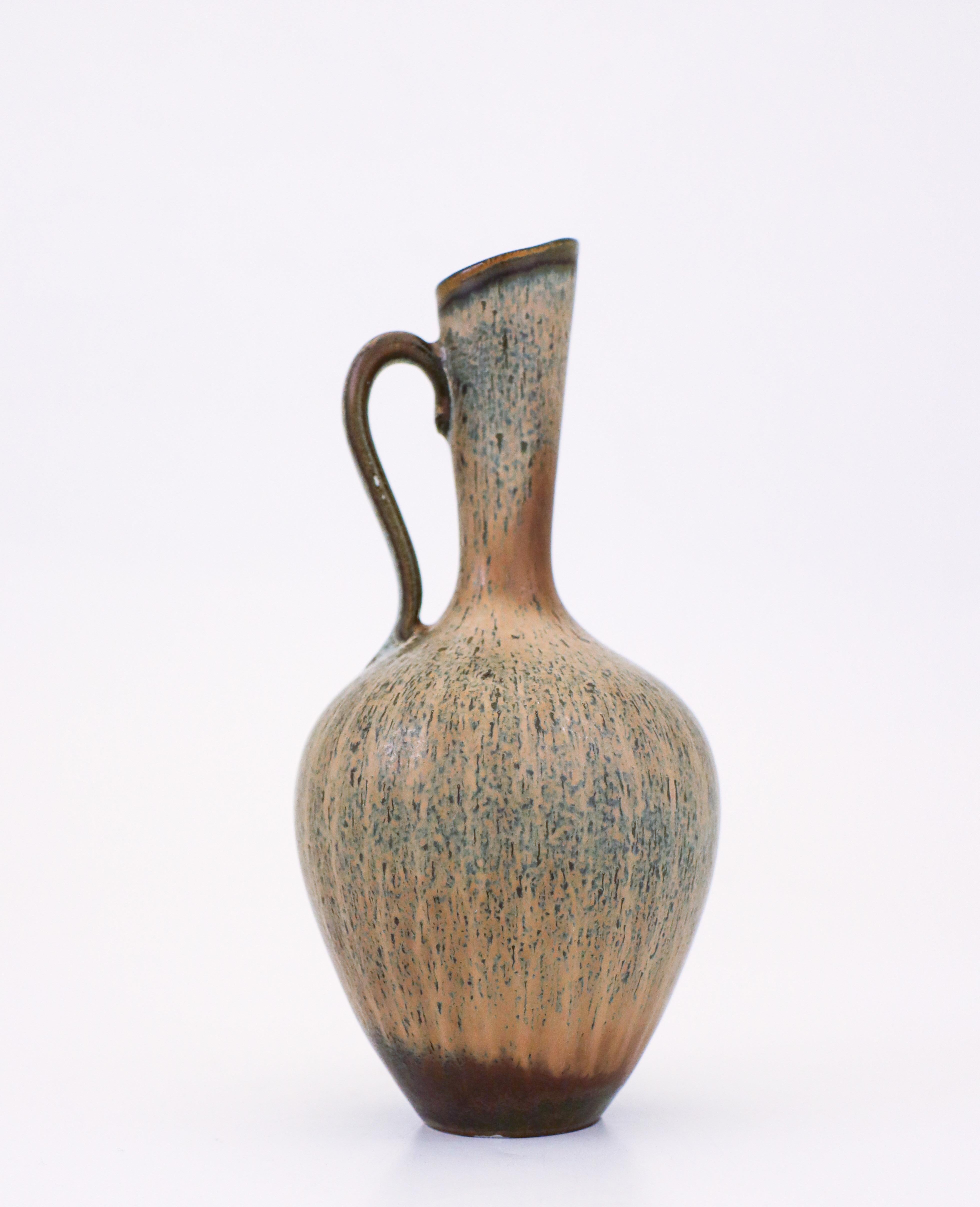 A gray speckled ceramic vase designed by Gunnar Nylund at Rörstrand. It is 17 cm (6.8