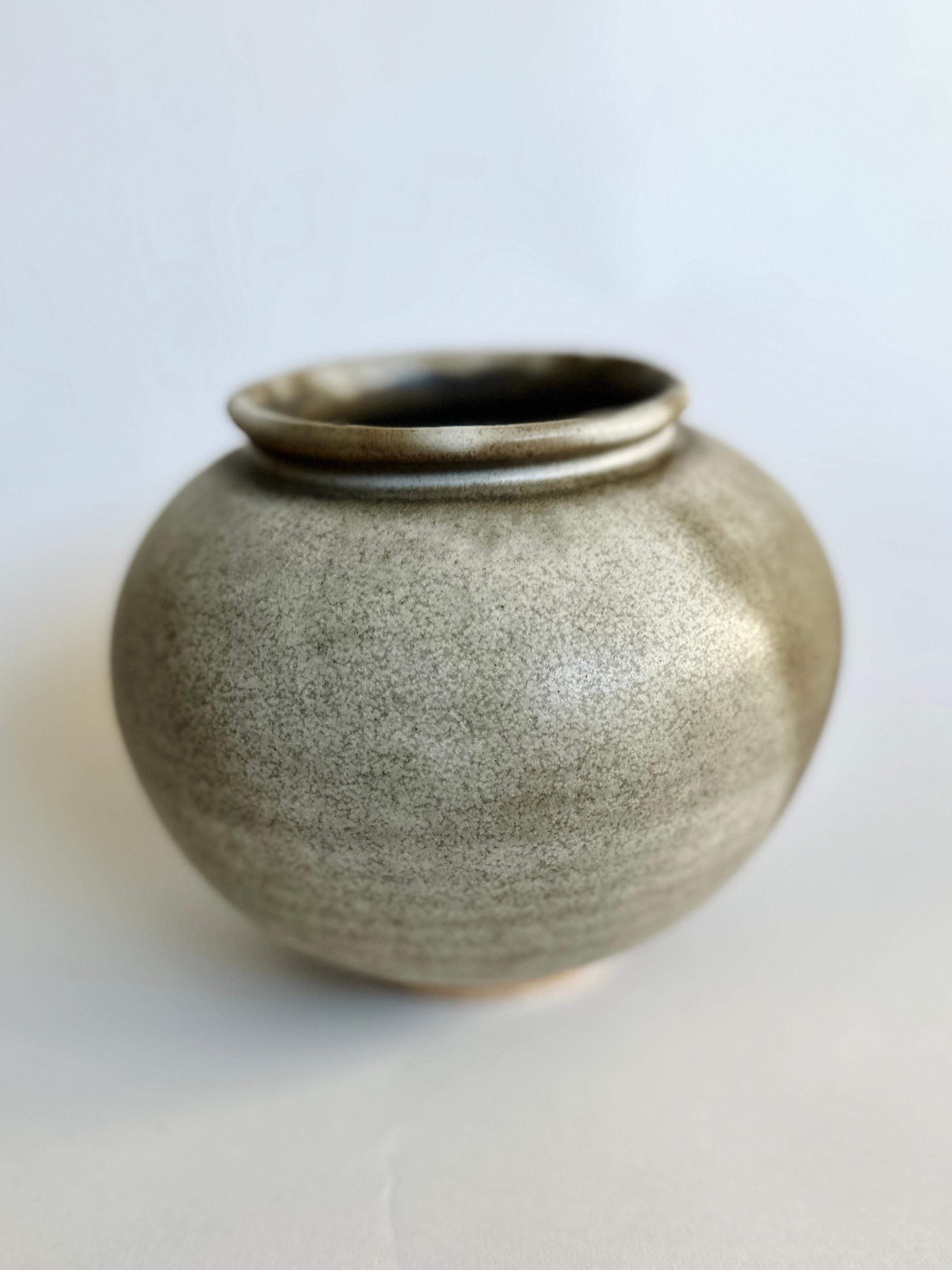 Wheel-thrown vase in beautiful light and dark earthy hues. Made from light stoneware, this piece serves as a testament to the timeless beauty of heirloom pottery, bringing an organic serenity to your dearest spaces. If filled with water, it is