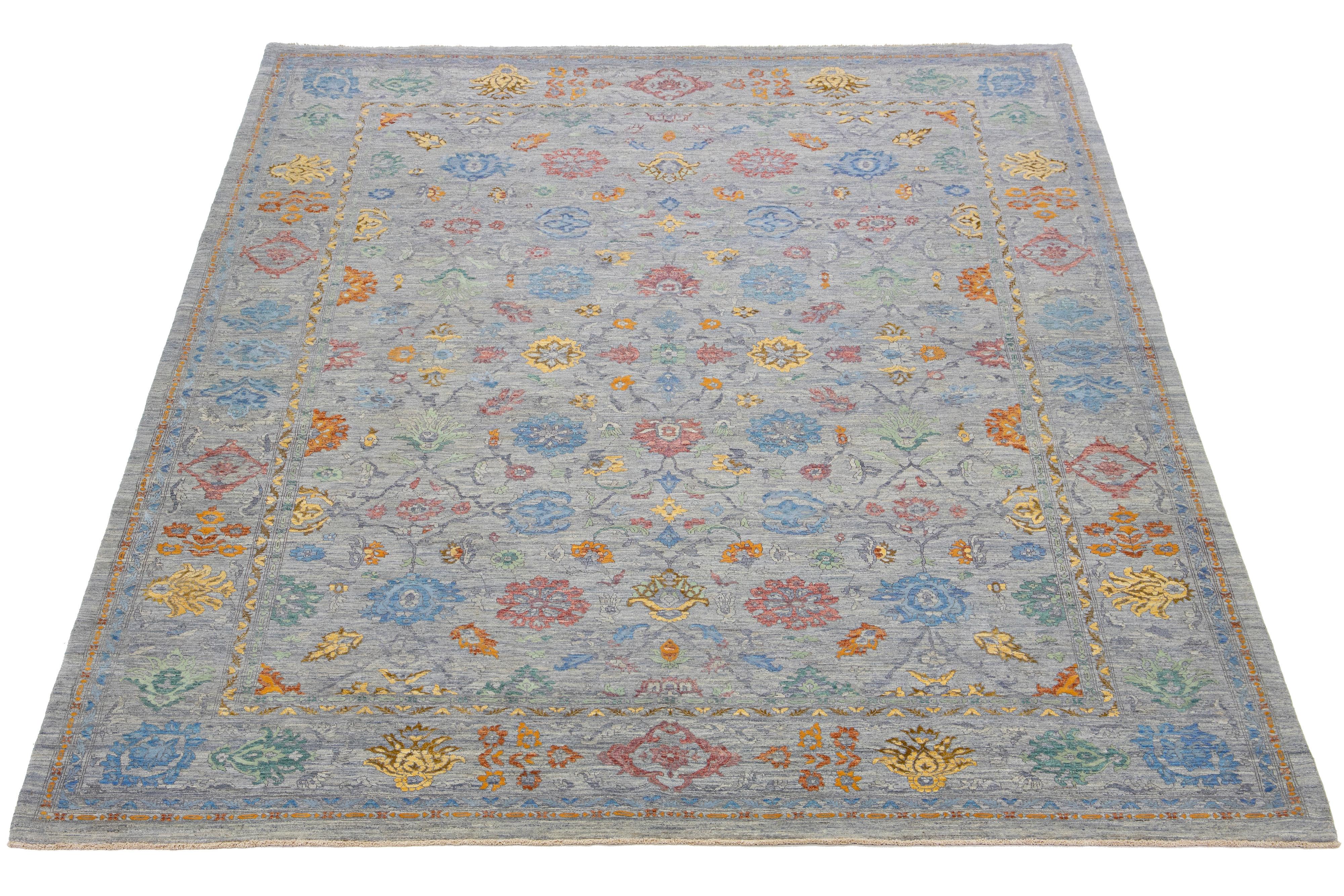 This hand-knotted wool and silk rug showcases a stunning gray-blue field with an all-over multicolor floral design. The addition of bright accents brings a touch of Transitional charm to its overall look.

This rug measures 10'2