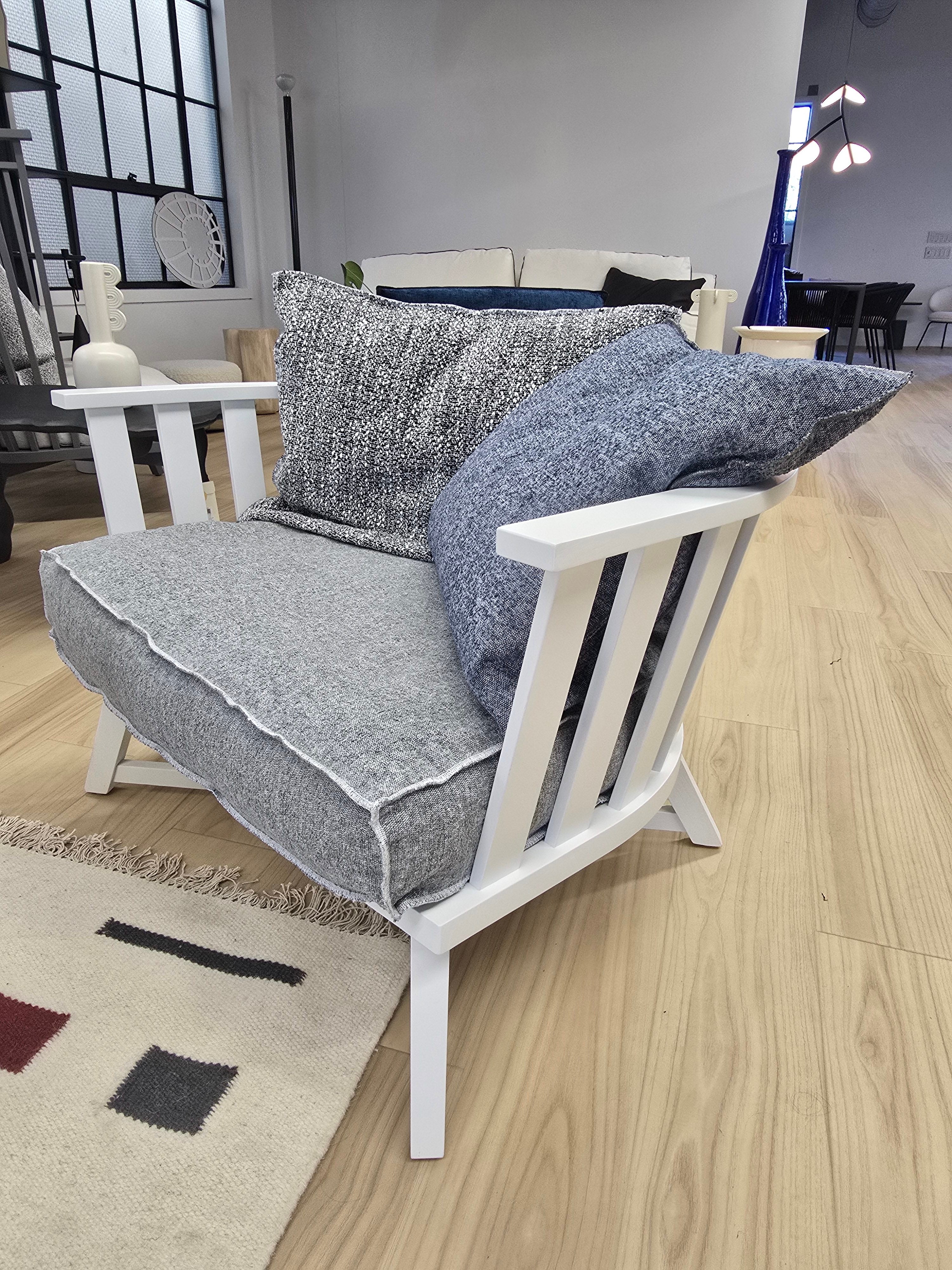 Gray Armchair by Paola Navone

Gray 07 is a wooden armchair whose distinctive sign is an enveloping low backrest in the shape of a semicircle made with slats. The solid wood legs intersect, forming a cross. The structure is made of natural painted