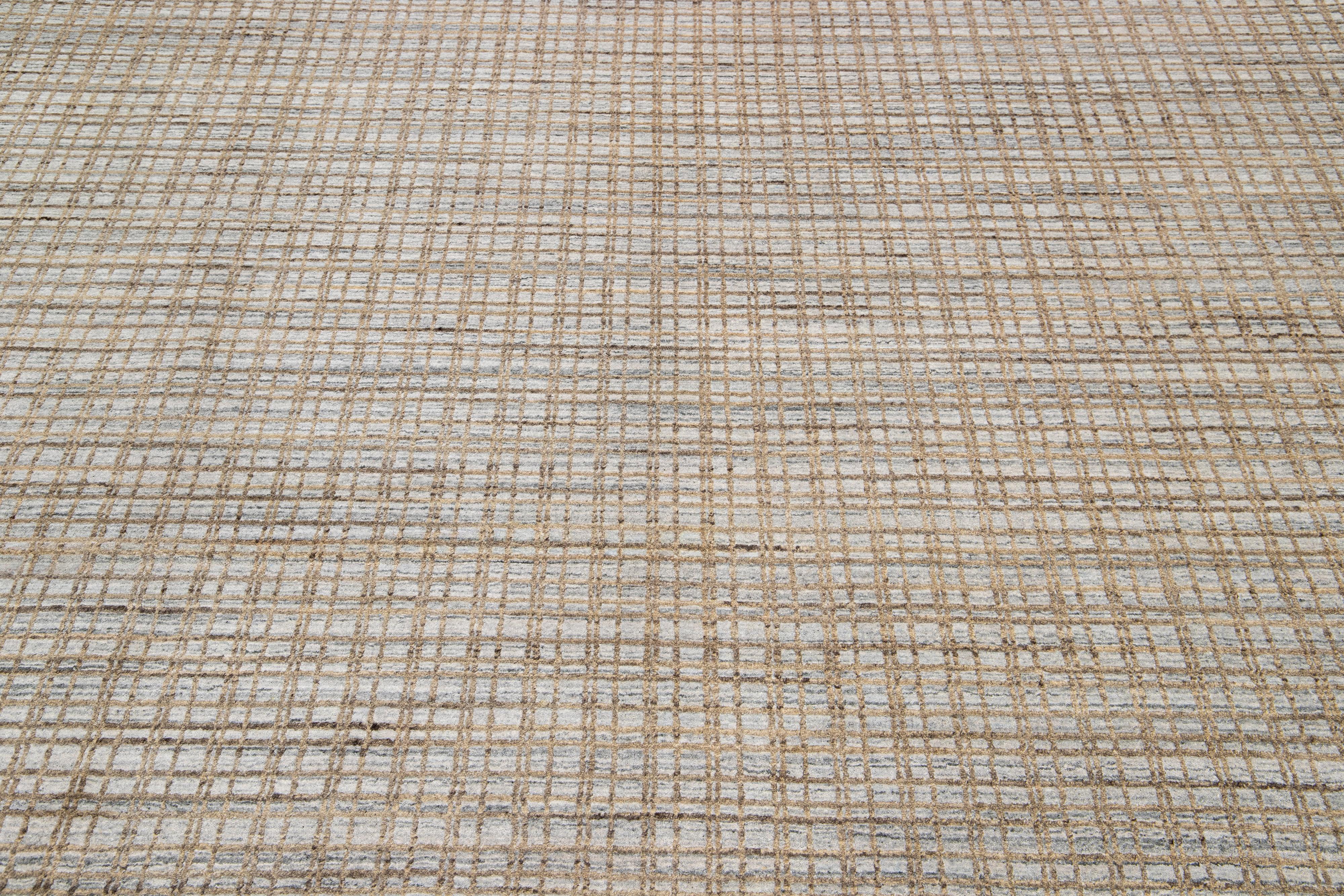 This rug is woven from a blend of Indian wool and silk and showcases a monochrome gray base with an intricate geometric pattern featuring complementary brown and golden tones.

This rug measures 8' x 10'.

Our rugs are professional cleaning
