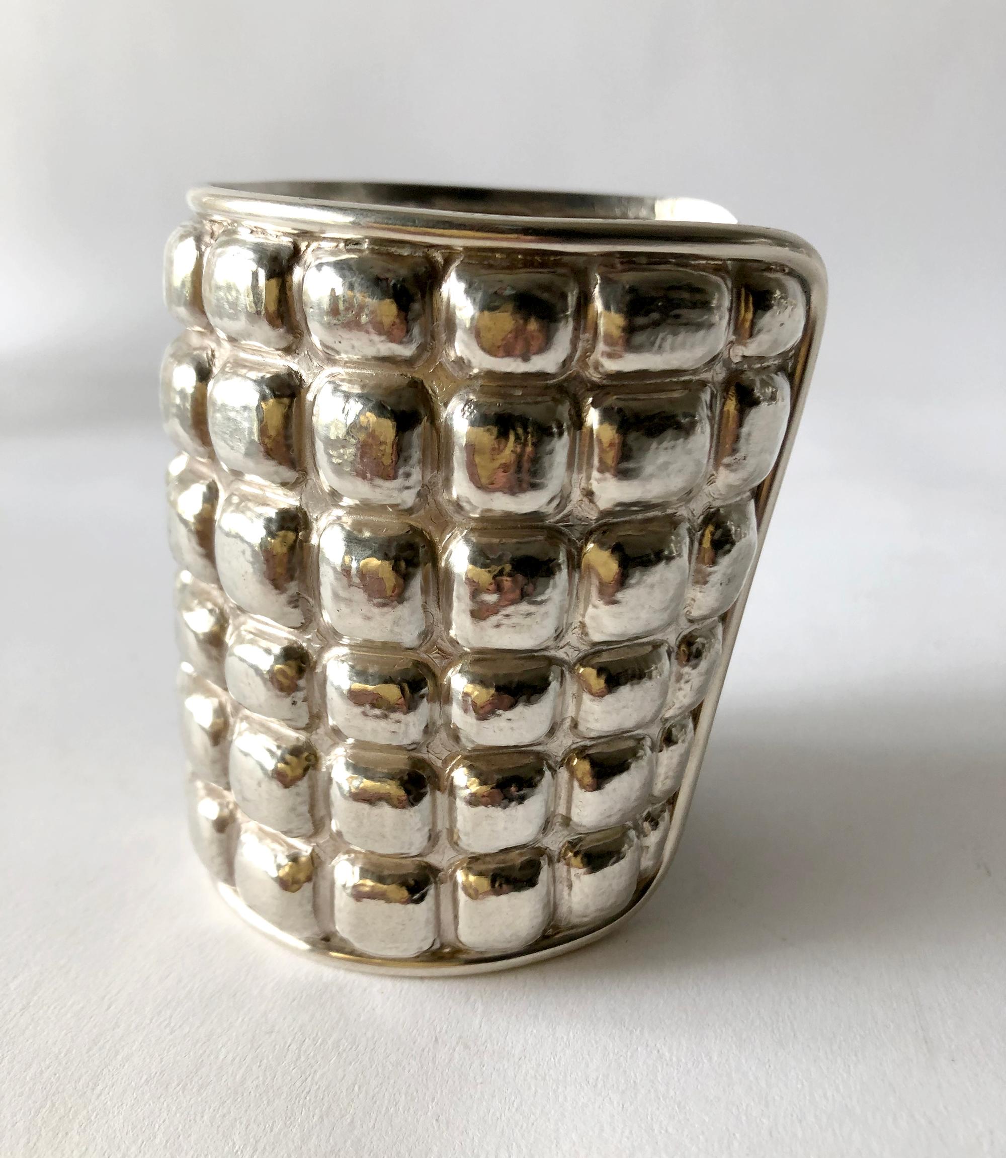 Important hand made sterling silver cuff bracelet with repousse´ waffle design created by architect and jeweler Graziella Laffi of Lima, Peru.  Cuff measures 9