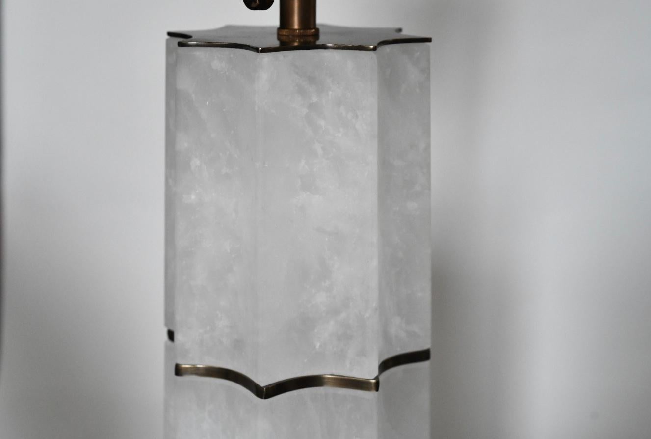 A pair of fine carved sculptured rock crystal quartz lamps with  brushed brass decoration. Created by Phoenix Gallery, NYC.
To the rock crystal: 17.75