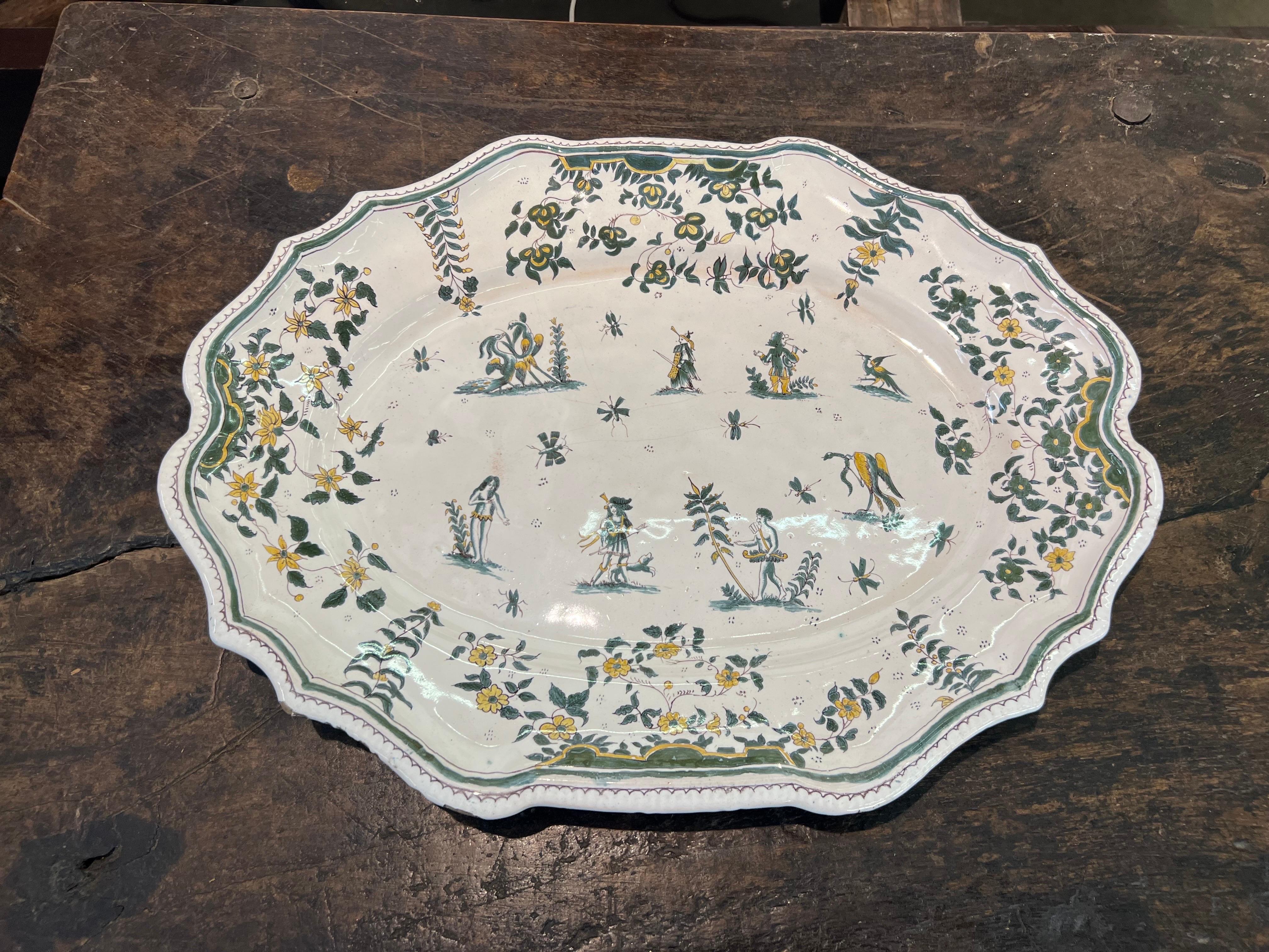 18th century polychrome French faience molded platter with scenes of gentry figures