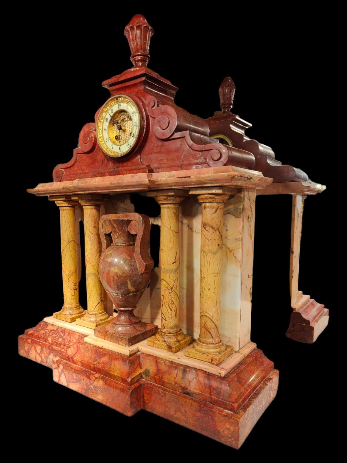 Great 19th century marble clock

Beautiful marble clock from the 19th century french. It is in very good condition with some unimportant faults. The clock works perfectly-it has an architectural shape and is possibly made to scale according to an