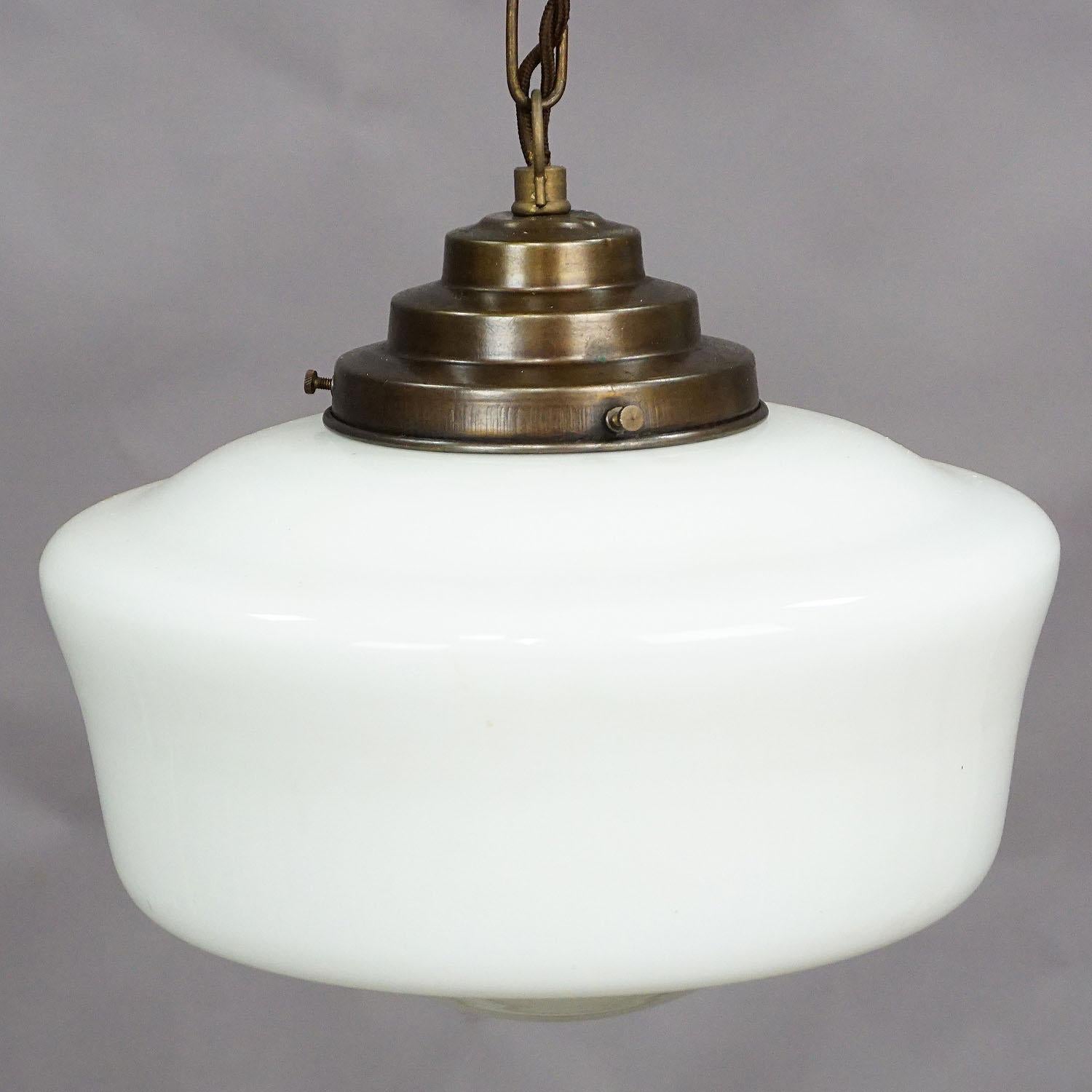 An antique functionalistic Art Deco pendant lamp with a white opaline glass shade and brass suspension. Cabling renewed, working order. With international E27 base lamp holder.

Measures: height 26.38