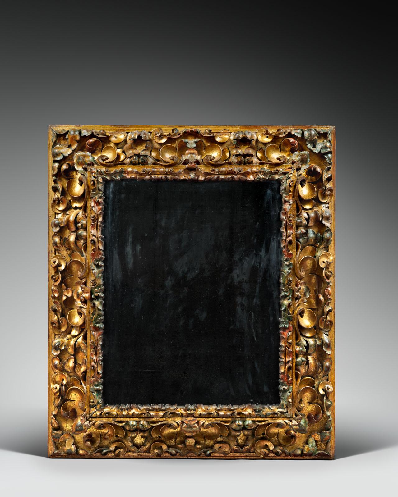 GREAT CARVED AND POLYCHROMED ITALIAN MIRROR
 
ORIGIN : ITALY
PERIOD : 17th CENTURY
 
Height : 103 cm
Width :  89 cm
Depth : 10 cm
 
Walnut wood
 
This large mirror is admirably carved with leaves and vigorous windings. The inner edge of the frame is