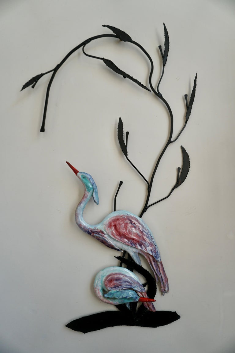 Heron birds wall art sculpture in ceramic.

This peaceful scene depicting two elegant herons, gracefully wading in a fresh water stream, adds a decorative touch of mother nature to your wall. Crafted in glazed ceramic on a metal