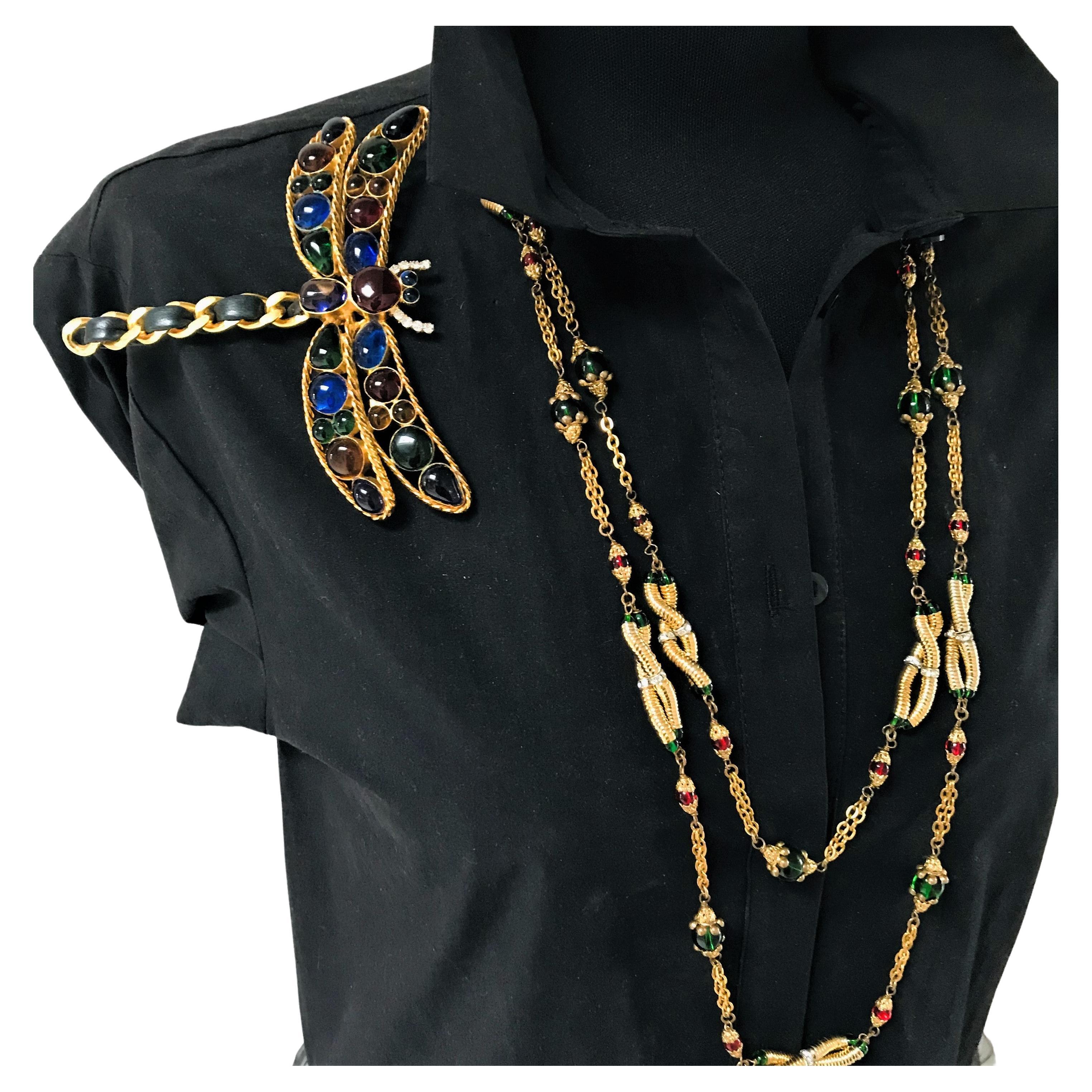 A highlight - spring has to come!
Wonderful, large dragonfly brooch made by Gripoix Paris in the 1970s /1980s.
The long body consists of the iconic Chanel chain with leather running through it. Two wings on either side with all Gripoix glass colors.