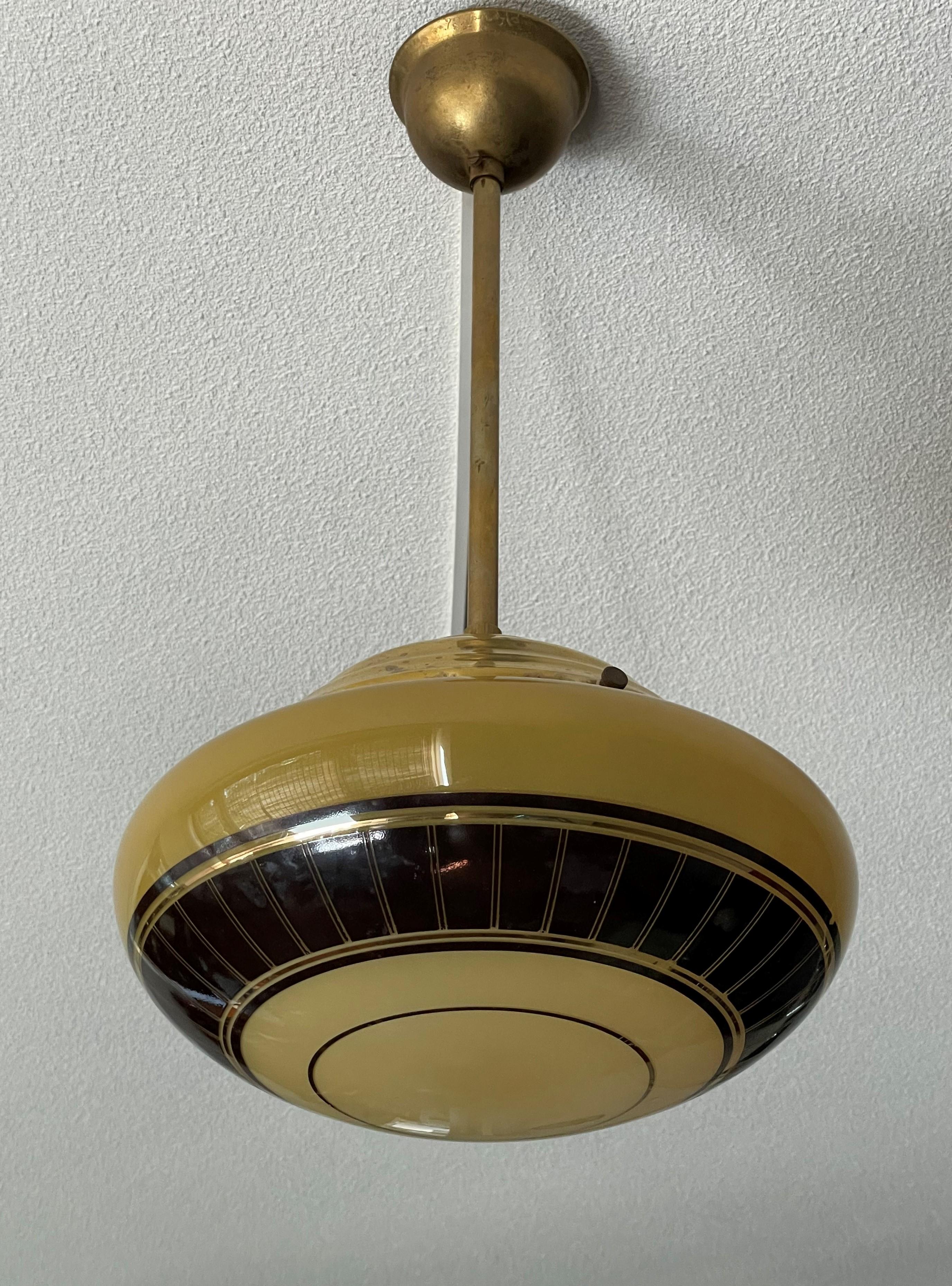 Wonderful design and cool looking midcentury ceiling lamp.

If you are a collector of rare and great looking midcentury design antiques then this stylish pendant from the 1950s could be perfect for you. This clean-lines design fixture comes with a
