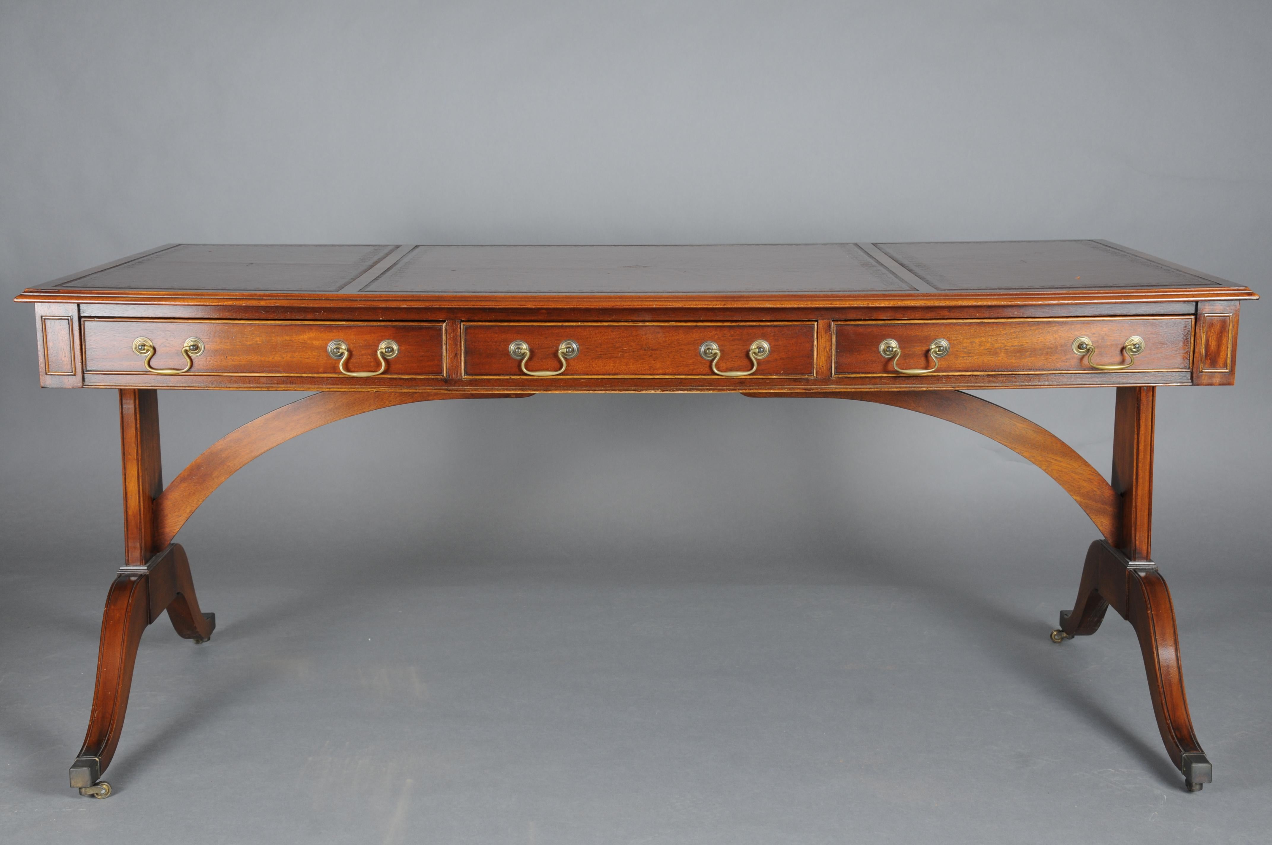 Great English Partner Desk/Writing Desk 20th Century, Mahogany

Solid mahogany, partially veneered. Three-drawer frame profiled on both sides, slightly protruding table top. Writing surface decorated with unusual gold embossing. Decorative brass