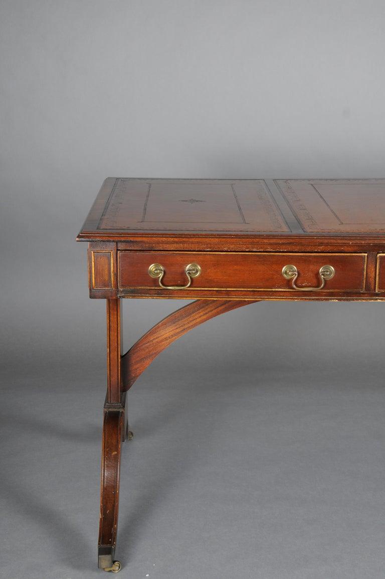 20th Century Great English partner desk,, mahogany 

Solid mahogany, partially veneered. Three-drawer frame profiled on both sides, slightly protruding table top. Writing surface decorated with unusual gold embossing. Decorative brass fittings.