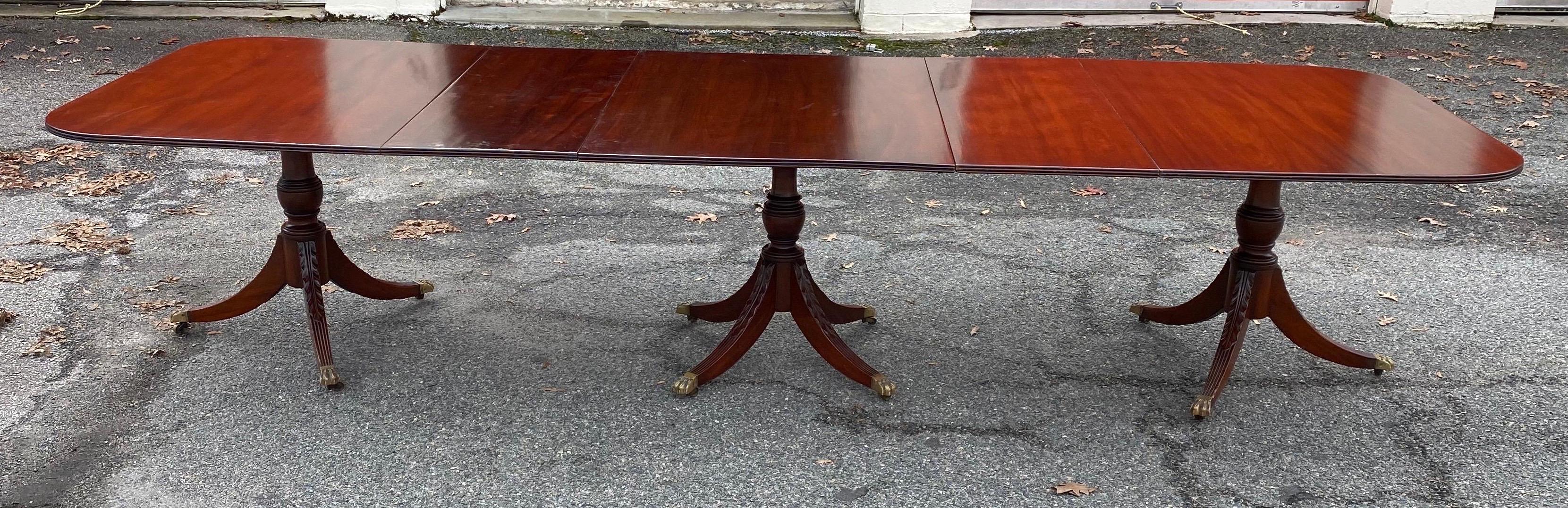 Great condition and color on this Georgian style mahogany triple pedestal dining table. Table has 2 removable leaves and is just shy of 140