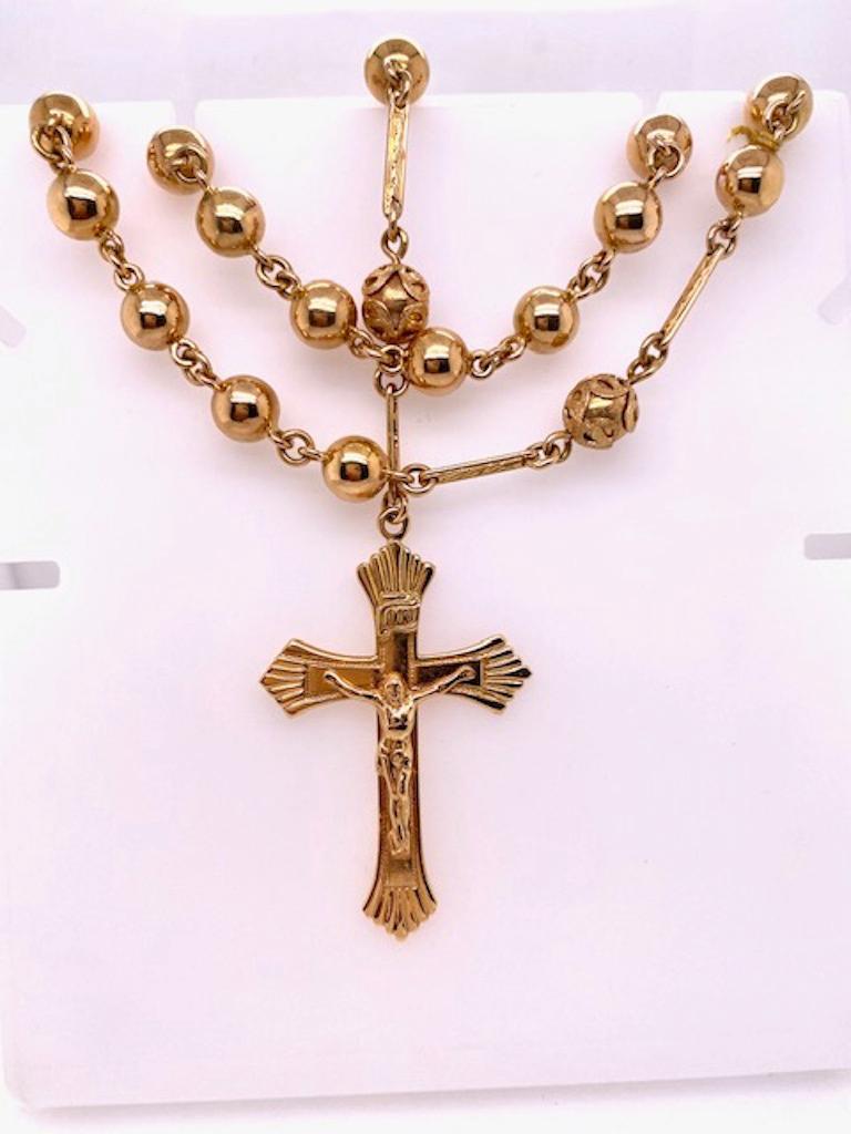 Large scale and solid gauge rosary.   Solid gauge 18K yellow gold.   The  chain, set with large beads,  is 36,