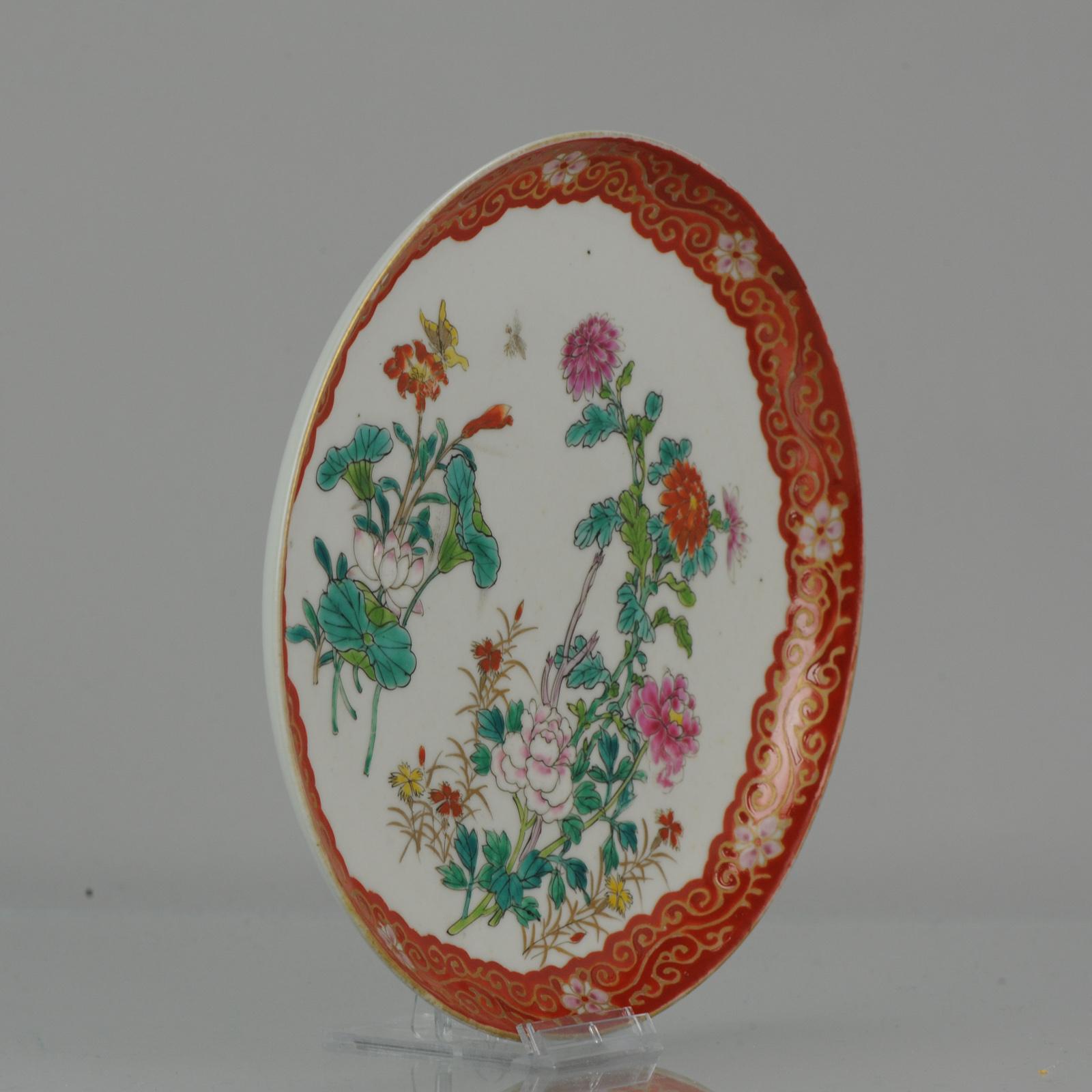 A very nicely decorated Japanese Porcelain dish in polychrome colors.

Marked at base with a 6 character overglaze mark, Hichozan Shinpo Zo.

The central scene is of a busy flower landscape with butterflies flying around. The rim nice copper red