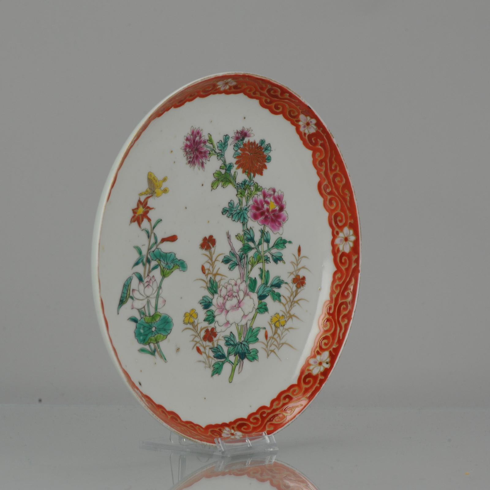 A very nicely decorated Japanese Porcelain dish in polychrome colors.

Marked at base with a 6 character overglaze mark, Hichozan Shinpo Zo.

The central scene is of a busy flower landscape with butterflies flying around. The rim nice copper red