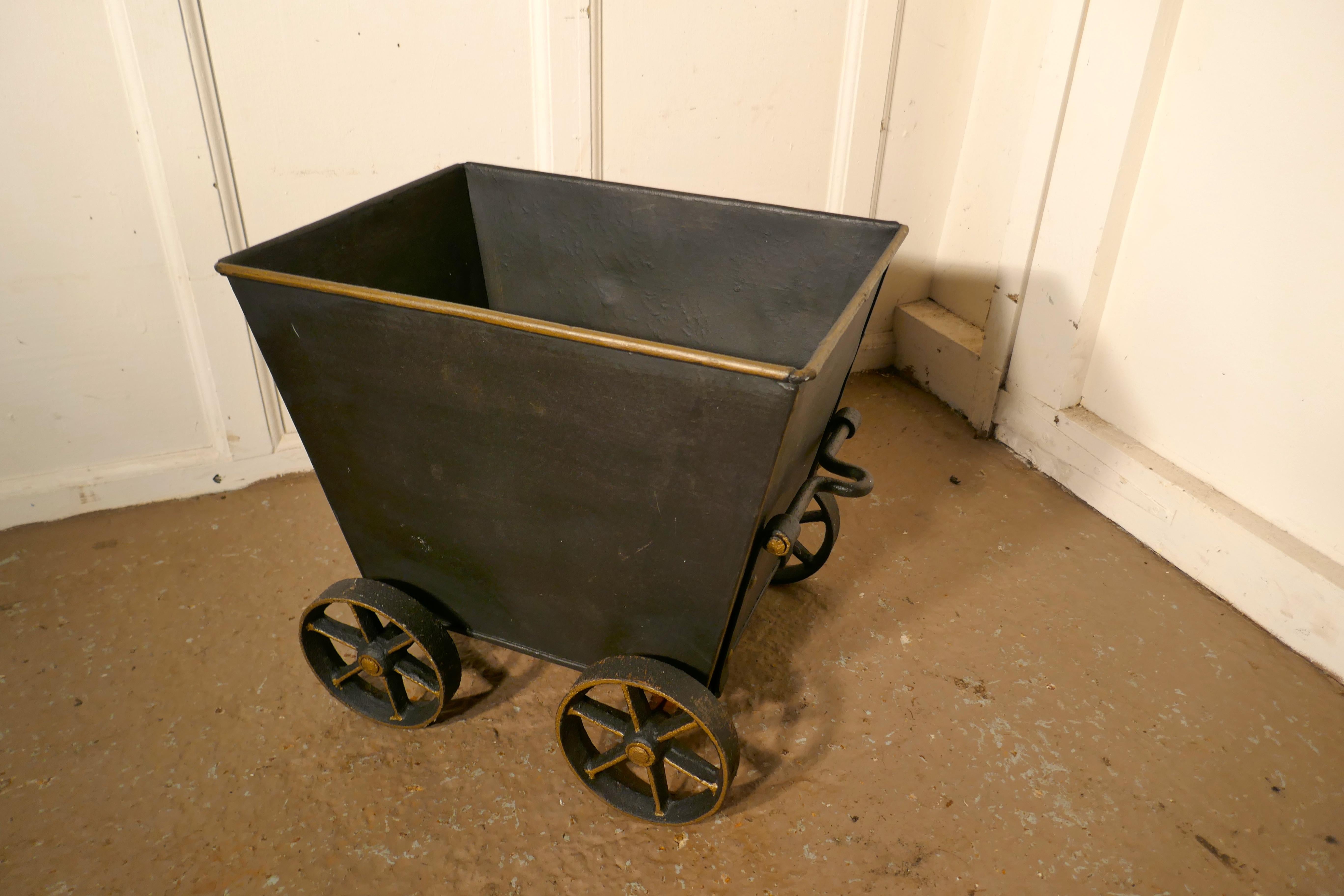 Great little blacksmith made coal wagon, coal scuttle.

A 20th century replica of a steam drawn coal wagon, this is handmade piece, it is made in heavy iron, it has hand forged wheels and towing mechanism, the top edge of the box as faded gold rim