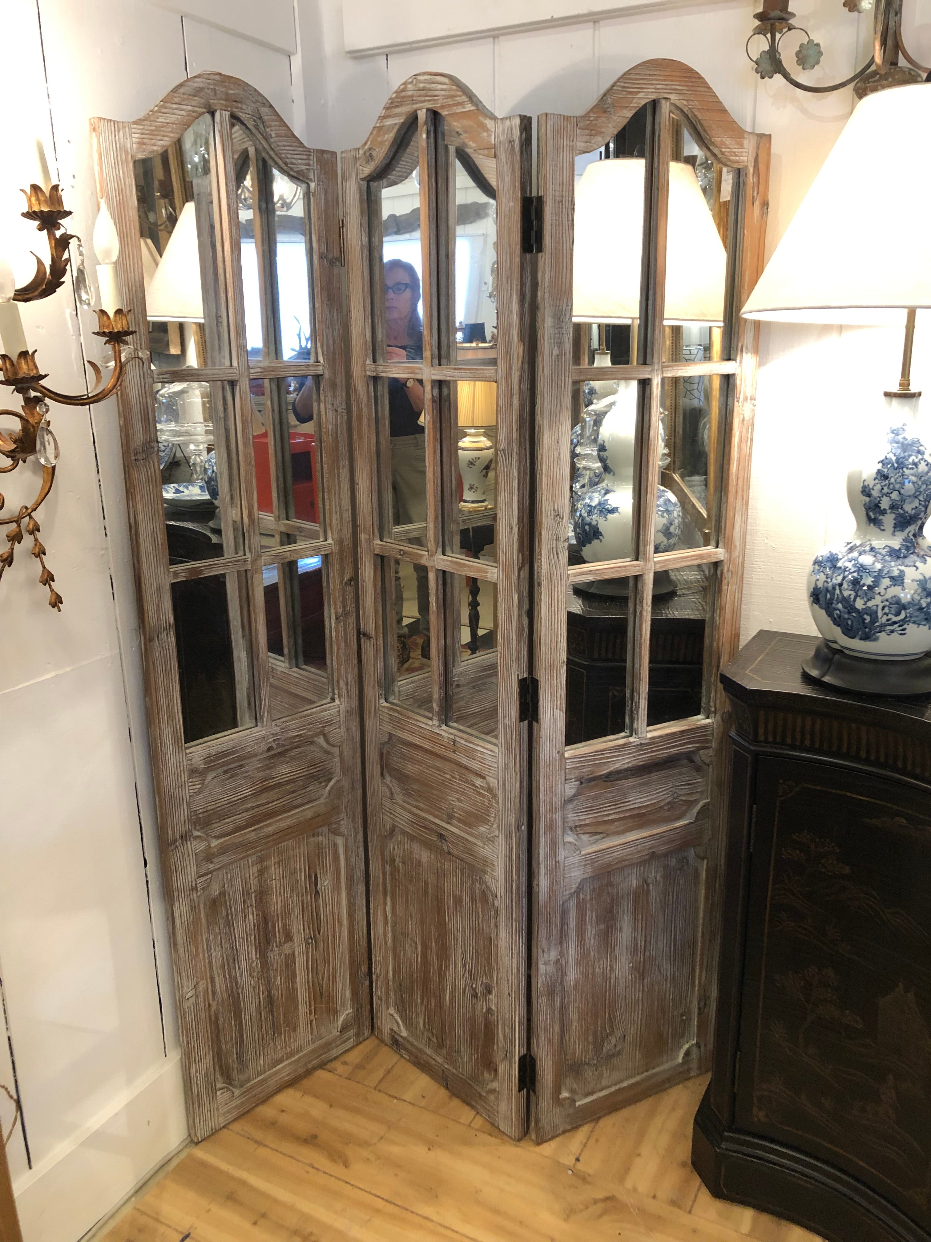 Attractive distressed wood and mirrored 3 panel screen having elegantly curved tops and carved panels. Color of wood is a pickled or cerused look. Very neutral.
Note: Pair available.