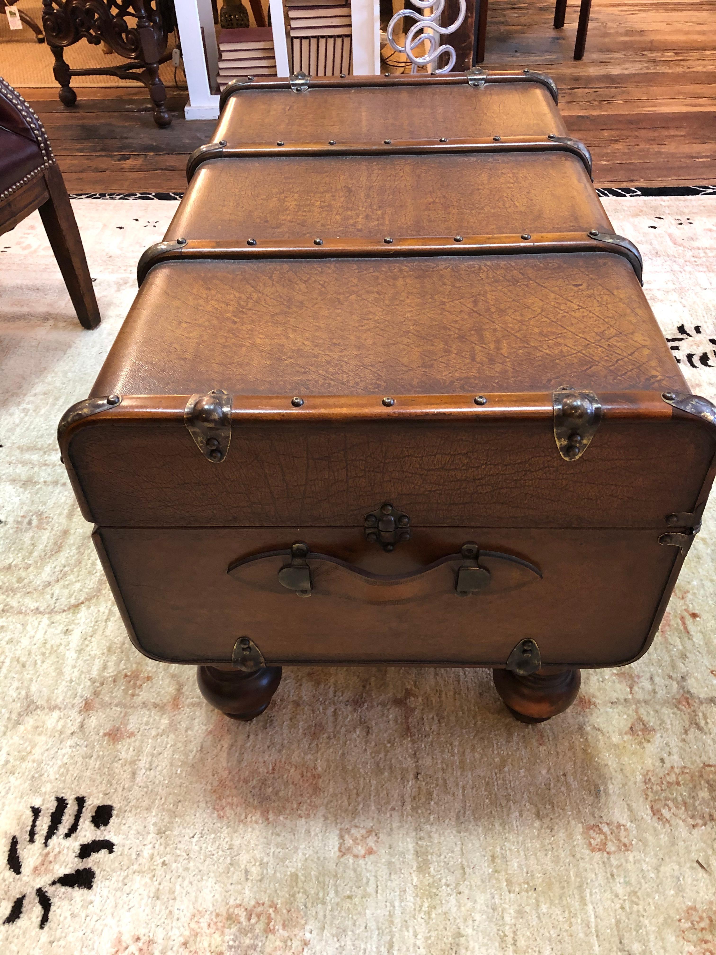 A fabulous rectangular shaped coffee table having a luscious handsome functional leather embossed trunk raised on four mahogany bun feet. The trunk has stunning wooden 