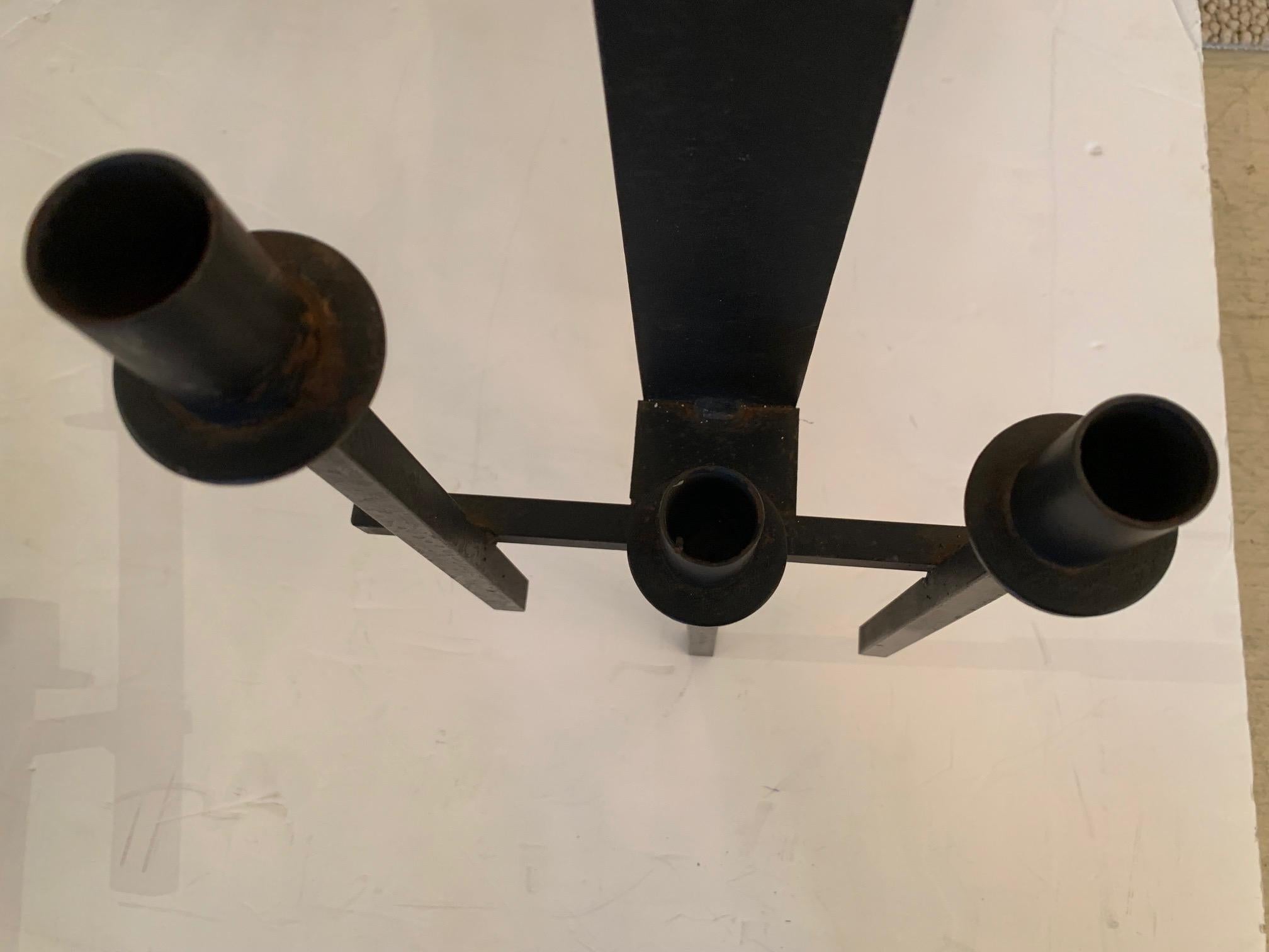 Pair of Mid-Century Modern black iron Frank Lloyd Wright style candle sconces having 3 arms in each.