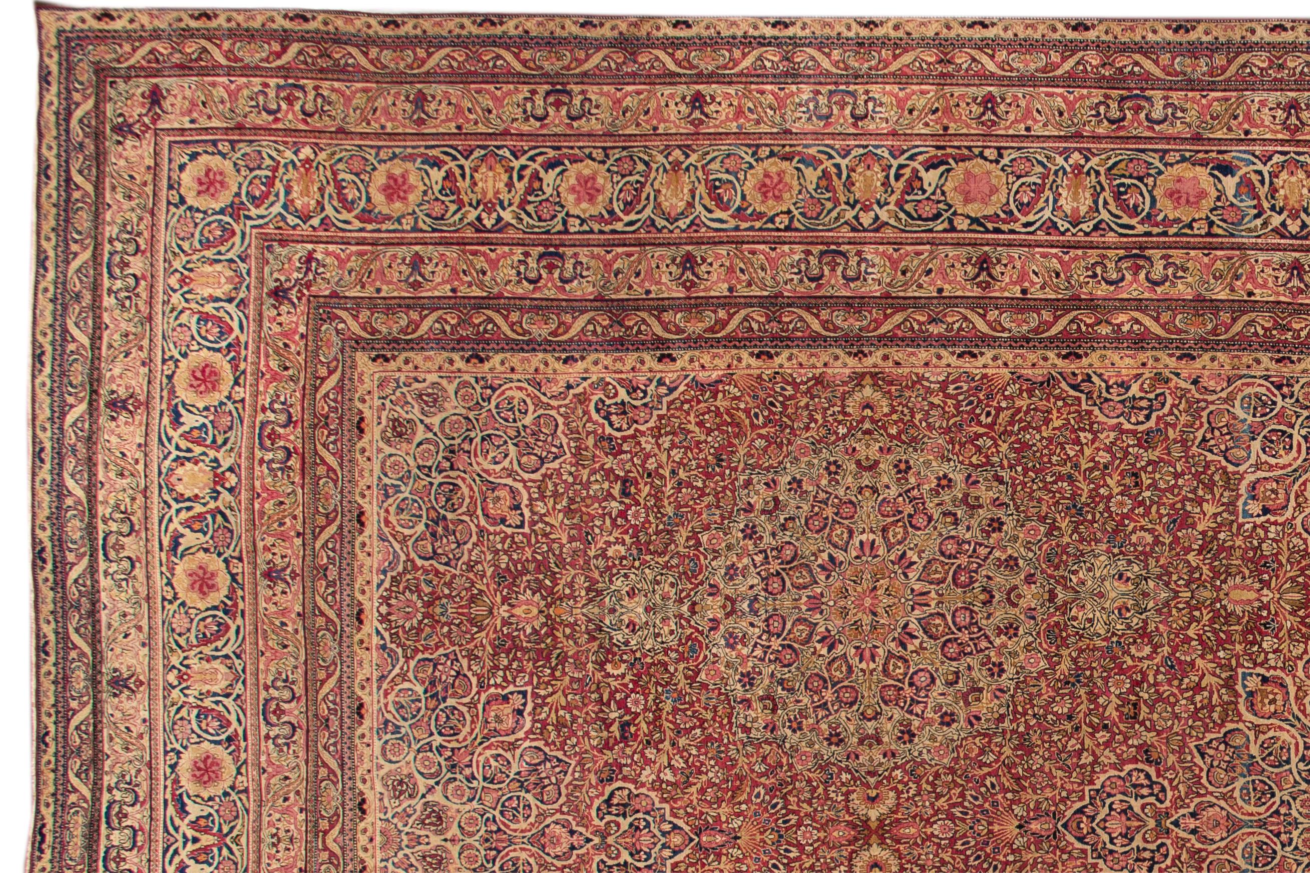 A hand-knotted antique Kerman rug with a floral all-over design. This rug measures 14'0