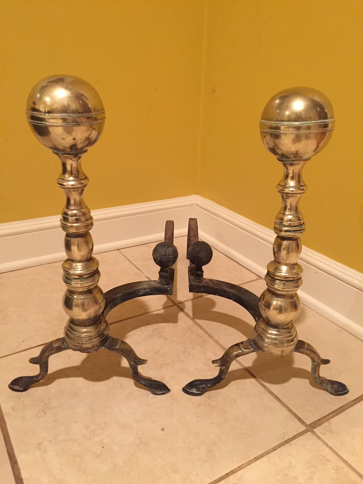 Classic chunky ball motif solid brass turn of the century andirons with a pair of handsome fireplace tools.

Measure: Fork:
32 1/2” H 
Tongs
31 1/2” H.