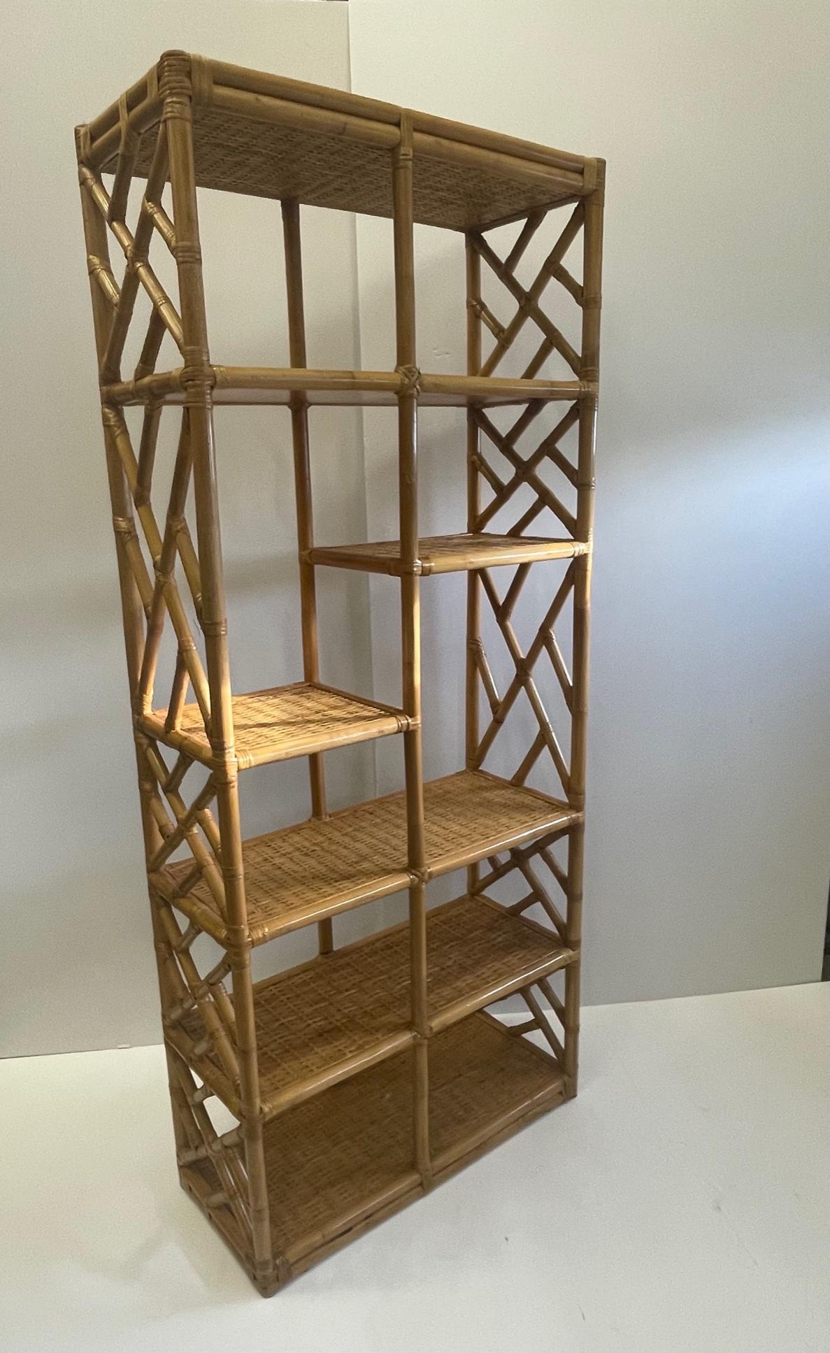 Versatile multiple shelf bookcase etagere having stunning mix of bamboo and woven rattan with decorative patterning on the sides.