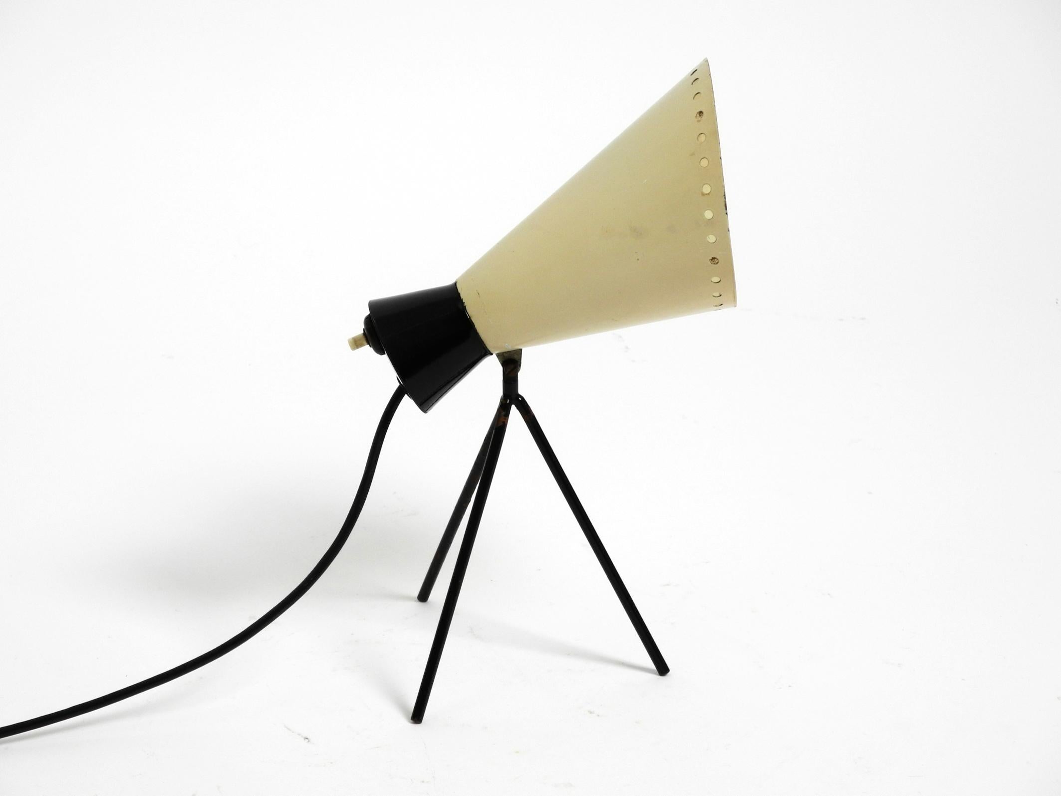 Great Mid Century Modern tripod table lamp by Josef Hurka.
Beautiful 50s design in the typical colors beige and black. Manufacturer is Napako. Made in Czech.
The absolute design classic from the 1950s.
The large lampshade can be swiveled up and