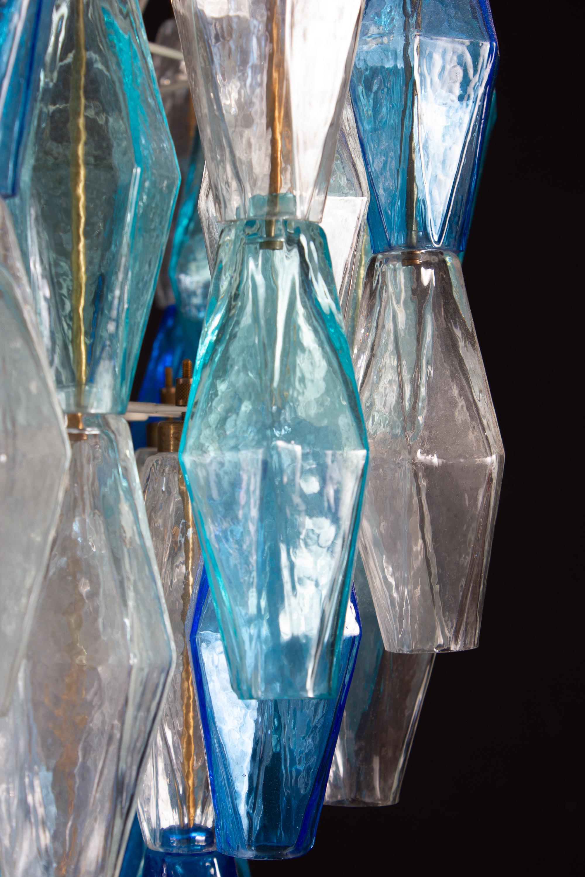This fantastic pair of chandelier consists with  circa 200  colored Poliedri glass of Murano.
Sapphire color variation with heavenly and aquamarine precious Poliedri.
Measures: Height without chain and canopy 88 cm (35inches). With chain and canopy
