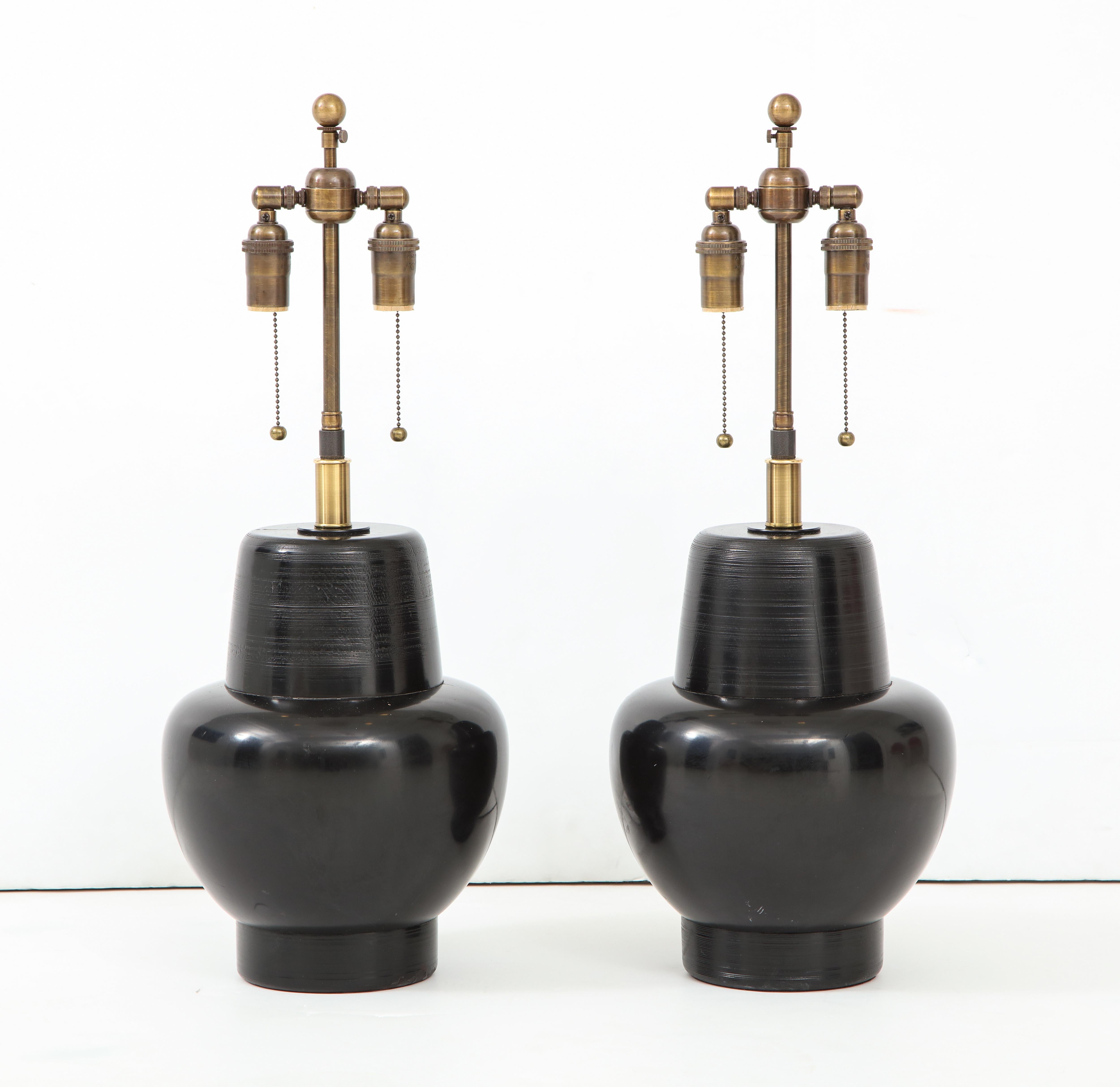 Wonderful pair of 1950s wooden lamps by James Mont.
The lamps have a black lacquered finish and they have been newly rewired with antique brass double clusters.
The height just to the top of the wooden lamp body is 13.5