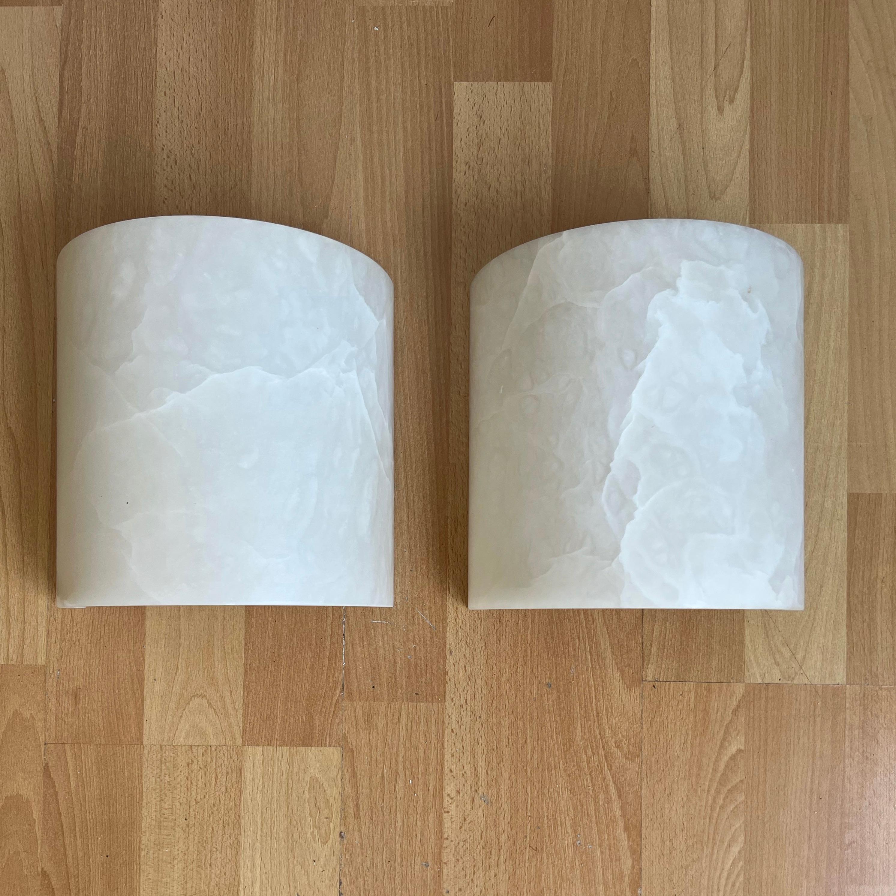 Handcrafted and very stylish pair of midcentury made alabaster 2-light (up & down) wall lights.

If you are looking for a great shape and practical size pair of sconces to grace your living space then these natural mineral stone fixtures could be