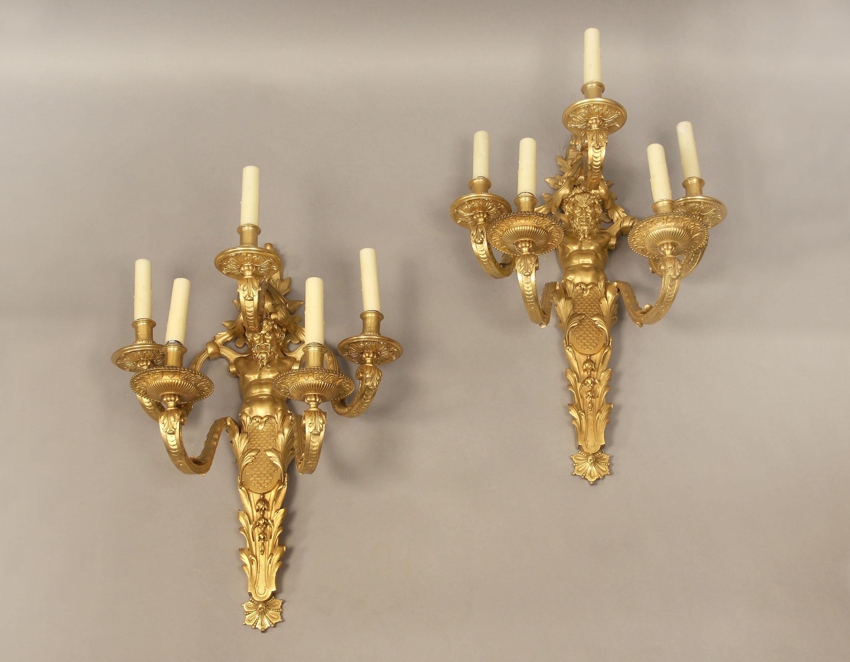 A great pair of late 19th century gilt bronze five light sconces

By Henry Dasson

Each centered by a bearded male mask, downward scale cast candle arms.

Signed Henry Dasson 1878 to the lower side of each sconce

Henry Dasson was considered