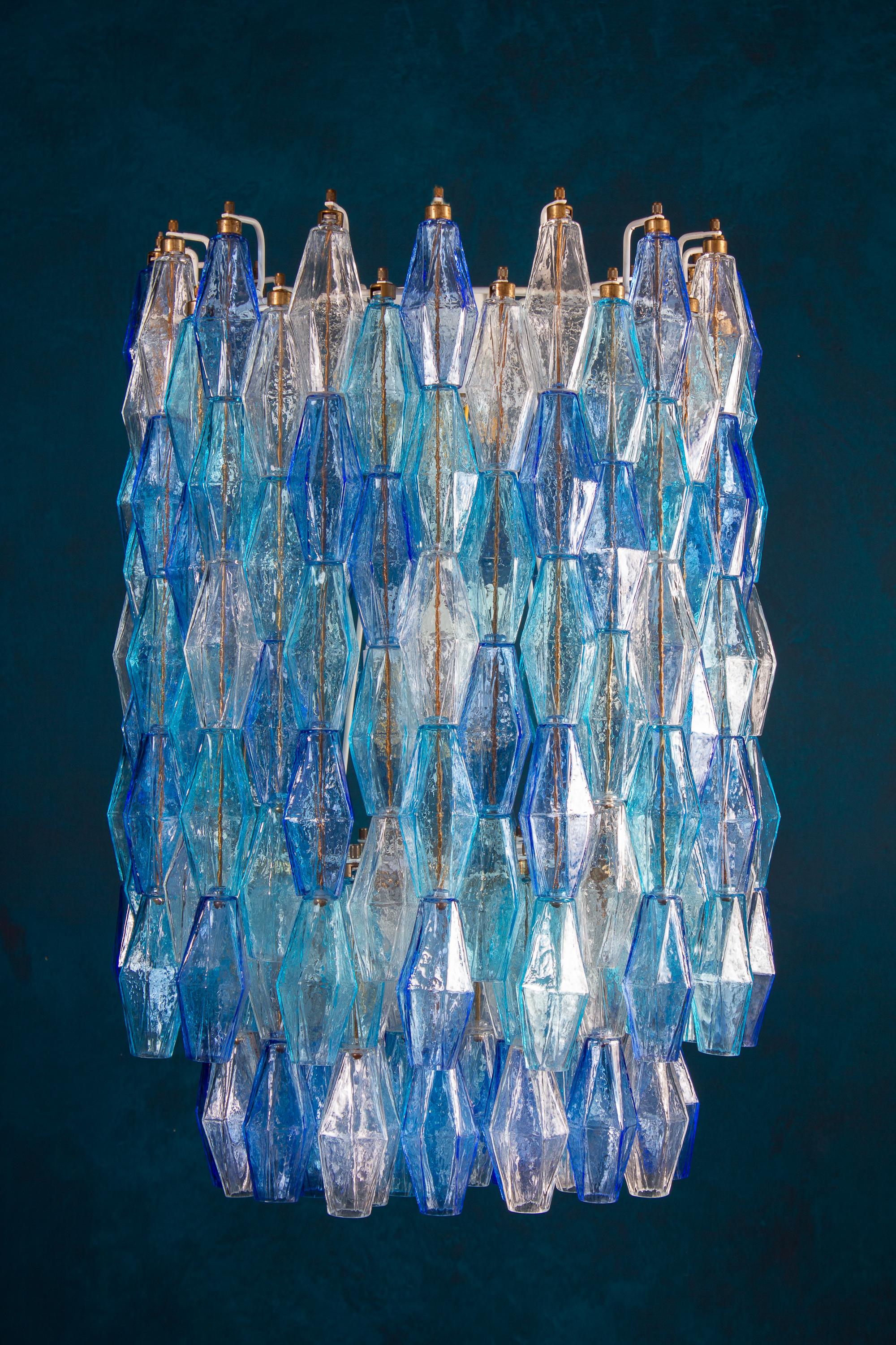 This fantastic pair of chandelier consists with circa 200 colored Poliedri glass of Murano.
Sapphire color variation with heavenly and aquamarine precious Poliedri.
Measures: Height without chain and canopy 88 cm (35inches). With chain and canopy