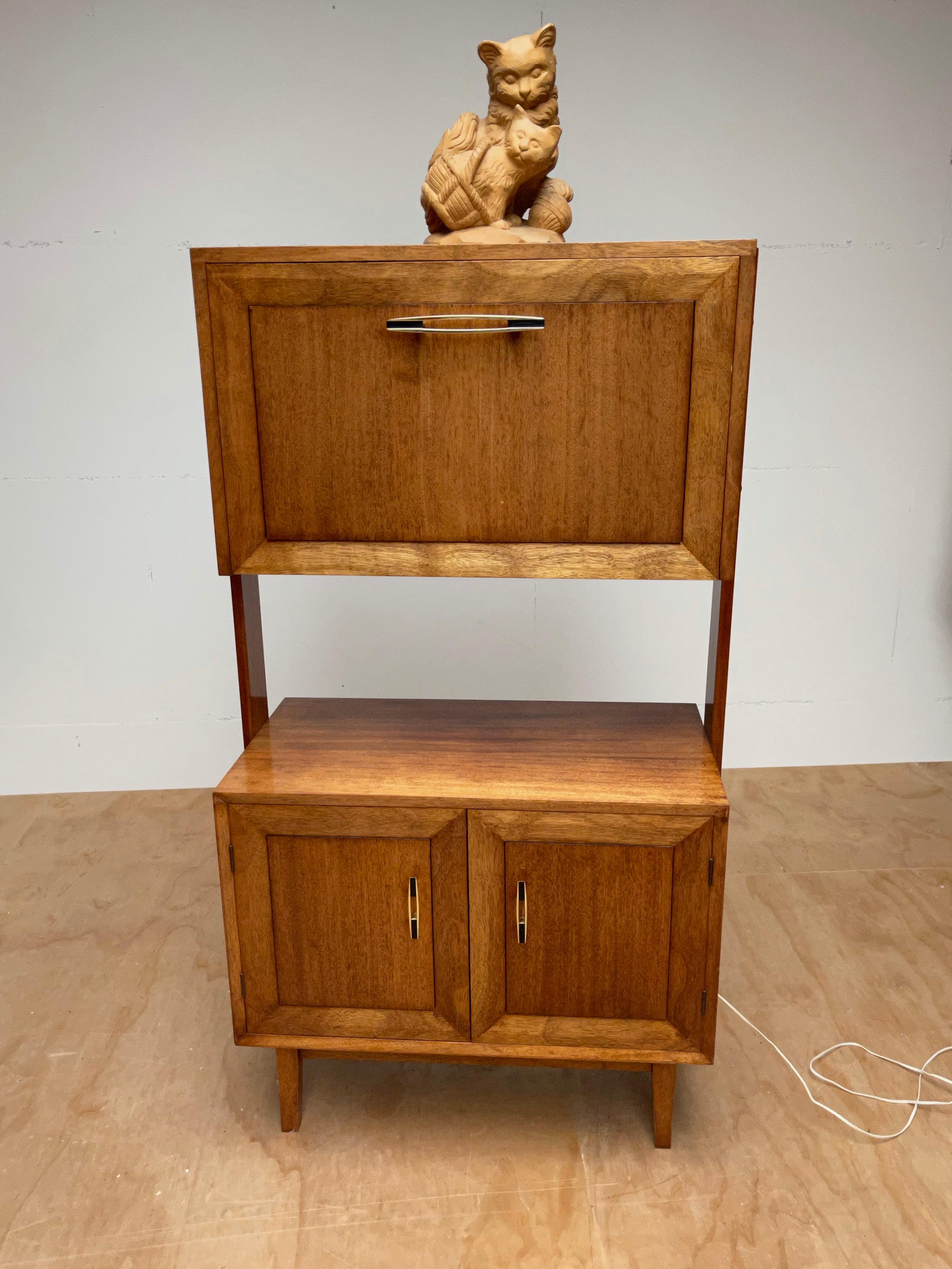 Handcrafted double tier credenza or dry bar.

This beautiful and handcrafted midcentury drinks cabinet is another one of our recent great finds. The stylish dovetails on the sides are proof that this midcentury piece of furniture is perfectly