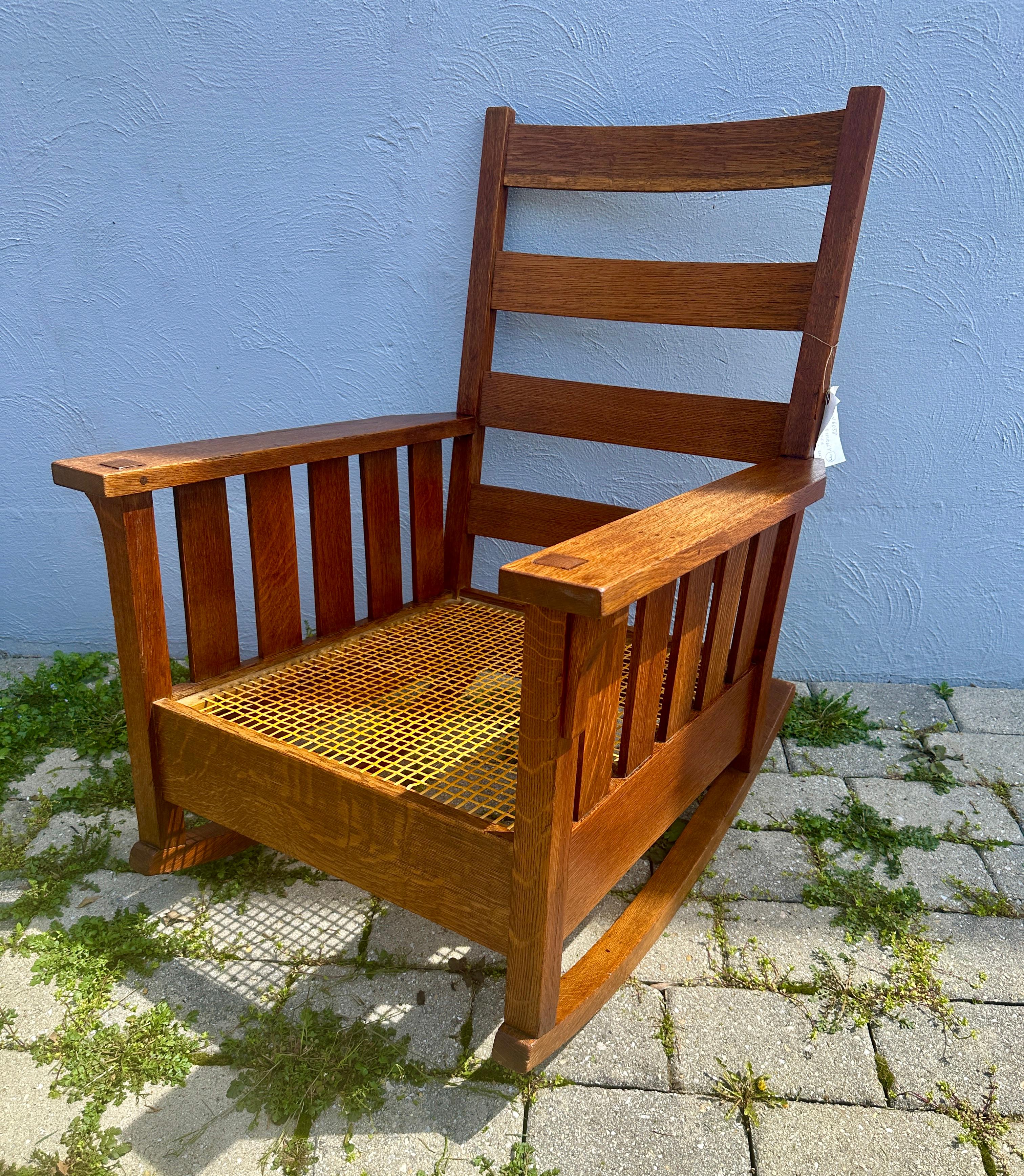 This is a special Gustav Stickley Are Rocker made in the early 1900s in excellent condition.  Both the original finish and the wood color are fabulous. There is an exceptional selection of quarter sawn oak with real through tenon construction in