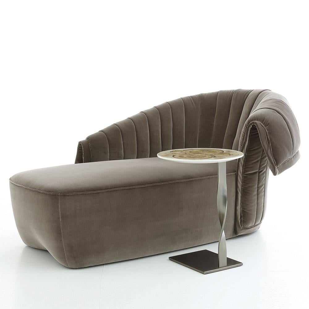 Sofá chaise longue de gran descanso con estructura de madera maciza,
tapizada y revestida con tela de terciopelo gris (Cat. B.).
Cojín en opción.
Disponible con otros acabados y colores de tejido bajo pedido.