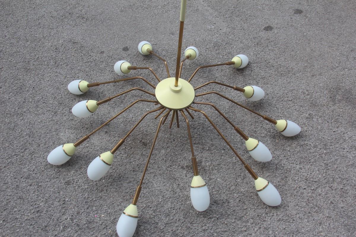 Great round midcentury Italian chandelier brass gold white glass metal Sputnik.
14 light bulbs max 40 watt each.
Stilnovo design attributed.

 