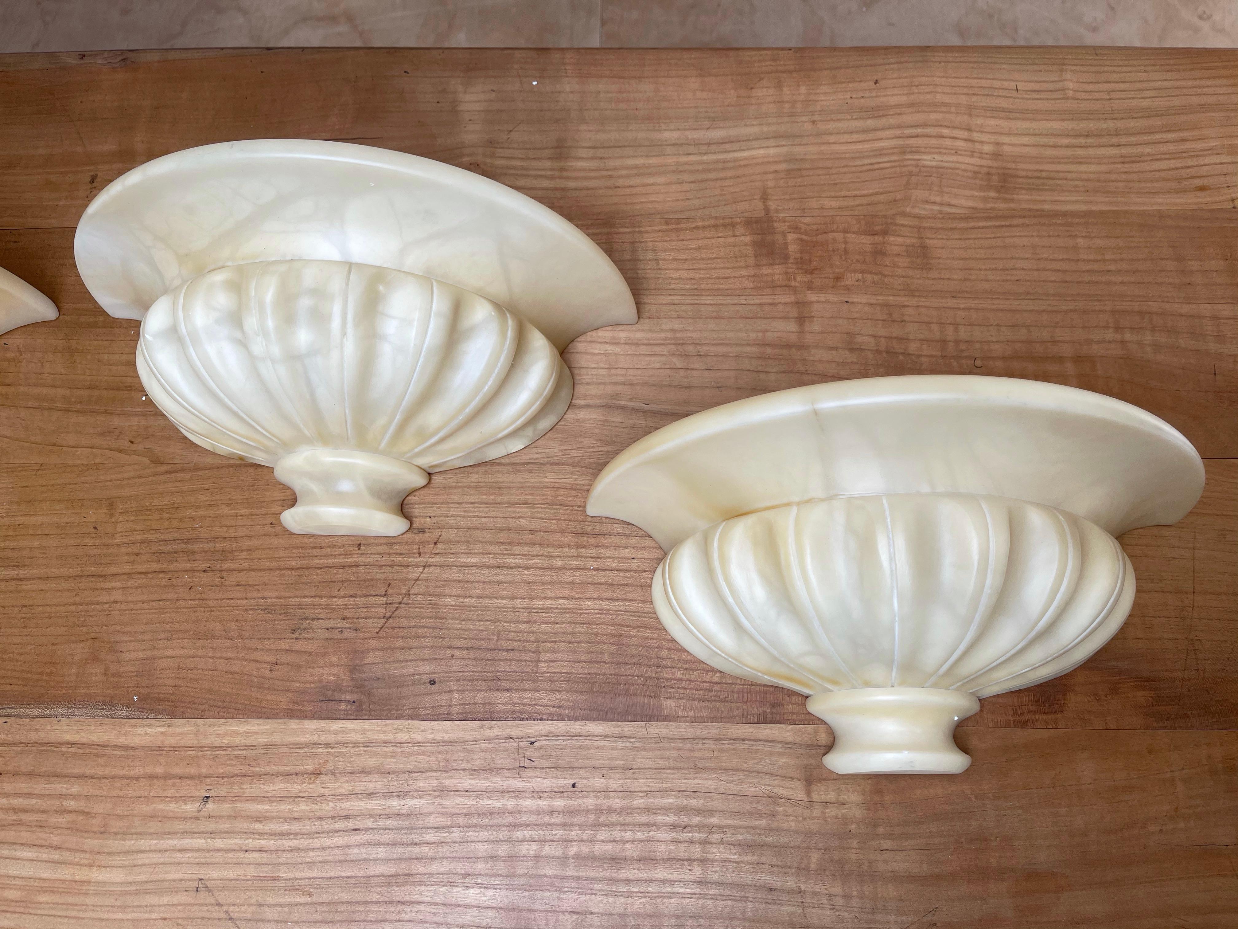 Wonderful group of 4 alabaster, classical design wall lamps.

These good size and great design wall sconces with warm light creating qualities are all in superb condition. There is something about the look and feel of these alabaster shades (with or