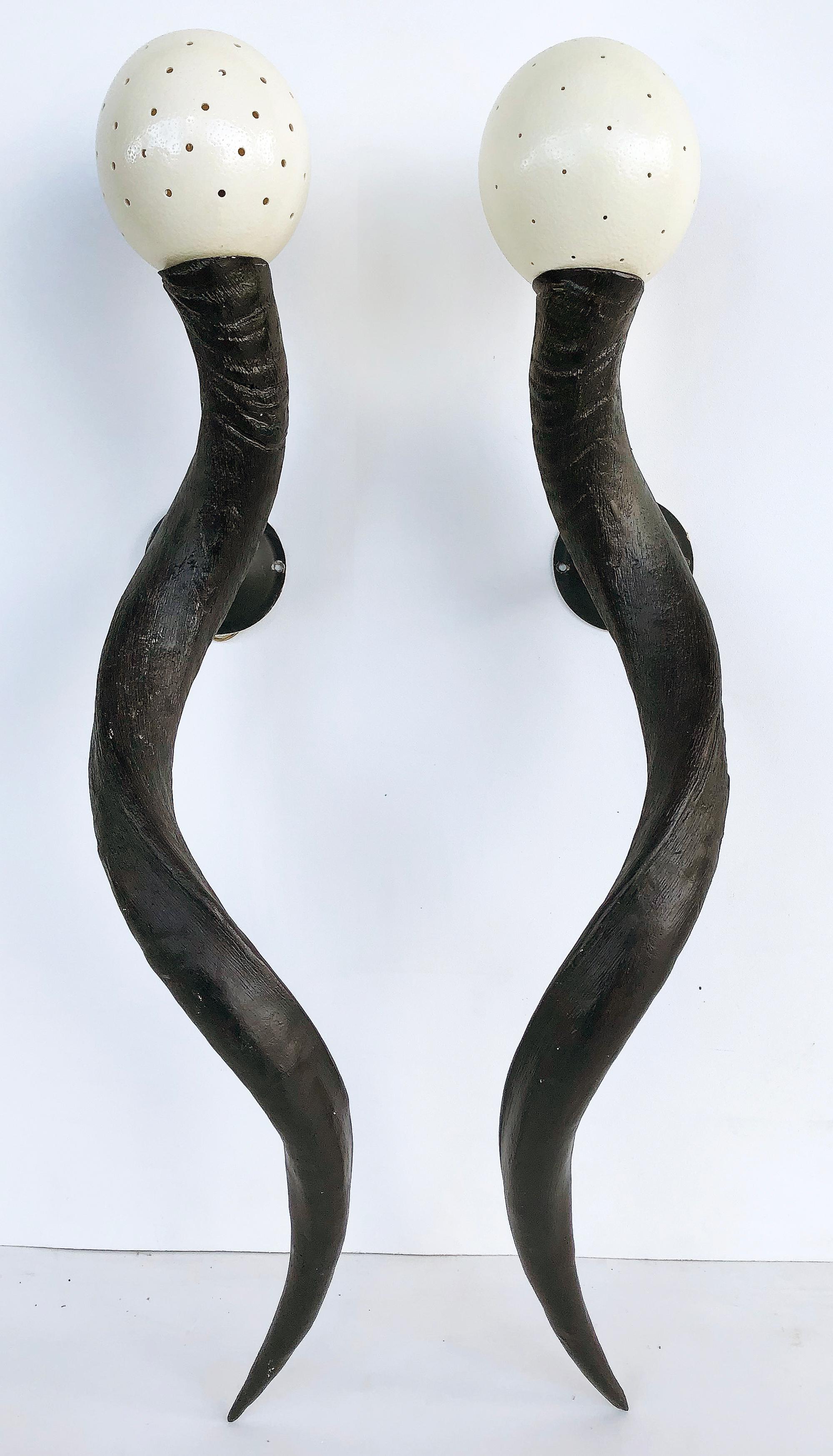 Greater Kudu horn and ostrich egg shell sconces, a pair

Offered for sale is a pair of Greater Kudu horn and ostrich egg sconces created in the style of Anthony Remile. Each horn supports a pierced ostrich egg shade which emits a soft mood light.