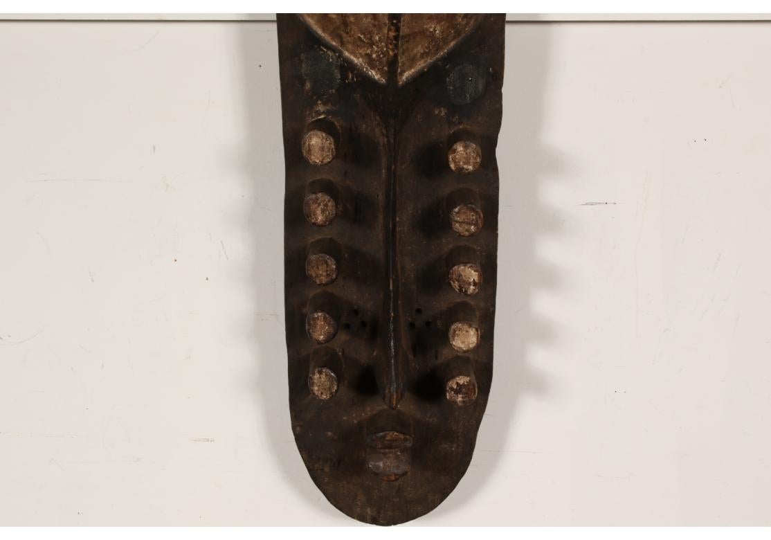 The Grebo Tribe reside in Southeast Liberia near the border of the Ivory Coast. Picasso once owned a Mask of this type and it undoubtedly figured in his emerging Modern style. In the form of an elongated abstract face with shaped white painted top