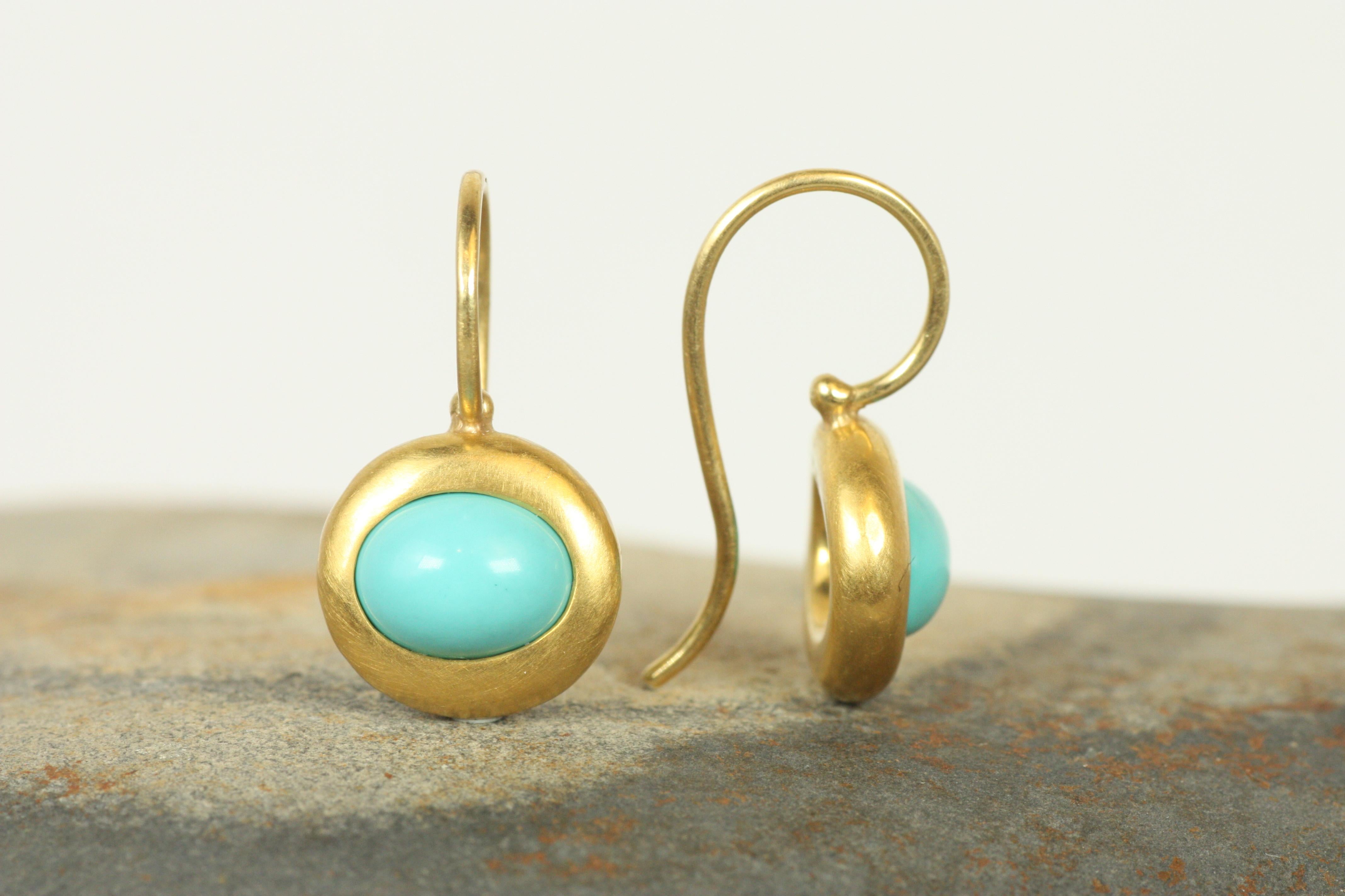 Elevate your look with these Greco Earrings featuring striking turquoise cabochons set in 22K gold. Inspired by ancient Greek designs, the handcrafted bezel setting and minimalist aesthetic create a timeless accessory. Perfect for adding a pop of