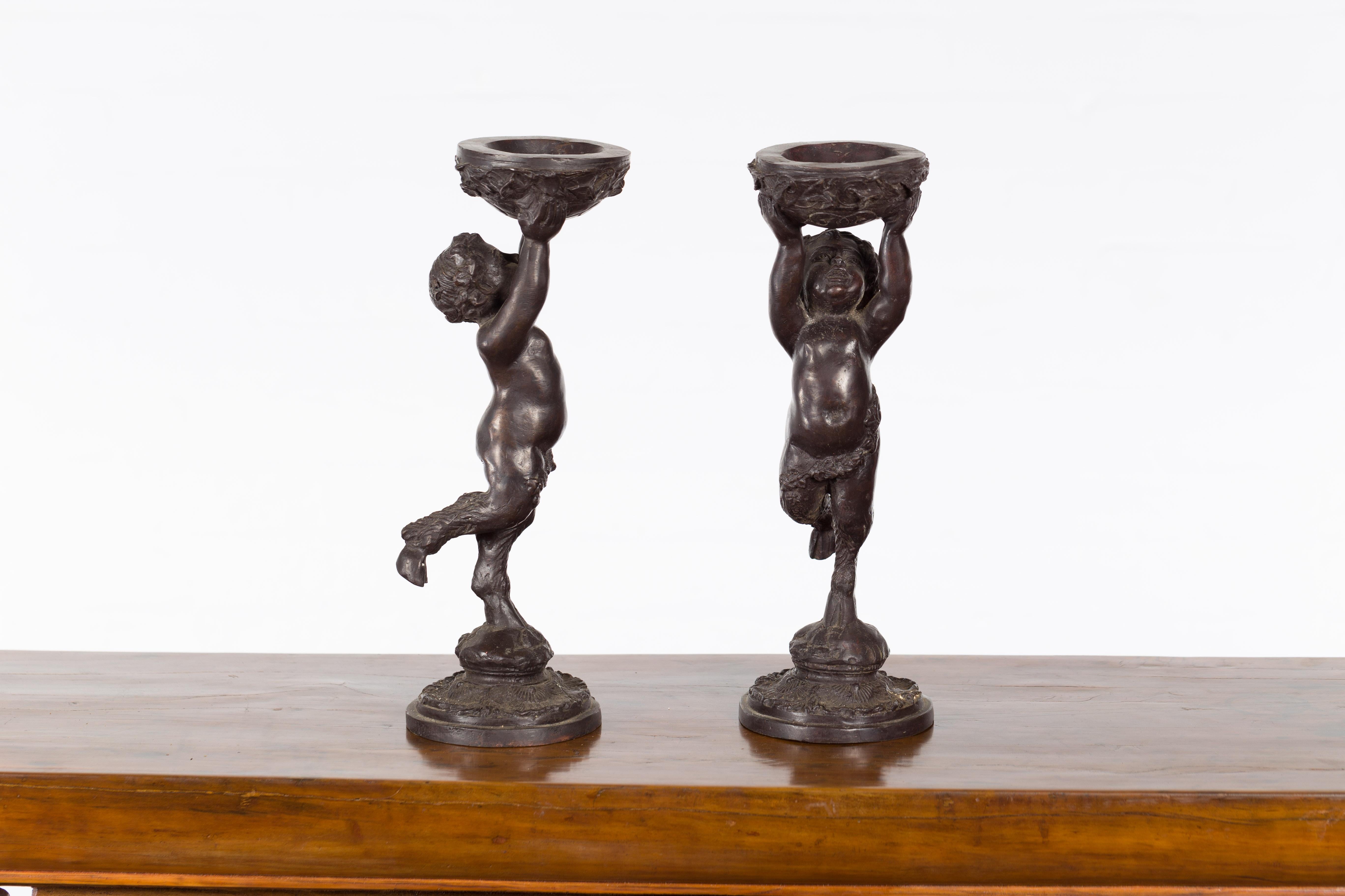 Greco-Roman Style Bronze Candle Holders Depicting Young Satyrs Holding Vessels For Sale 4