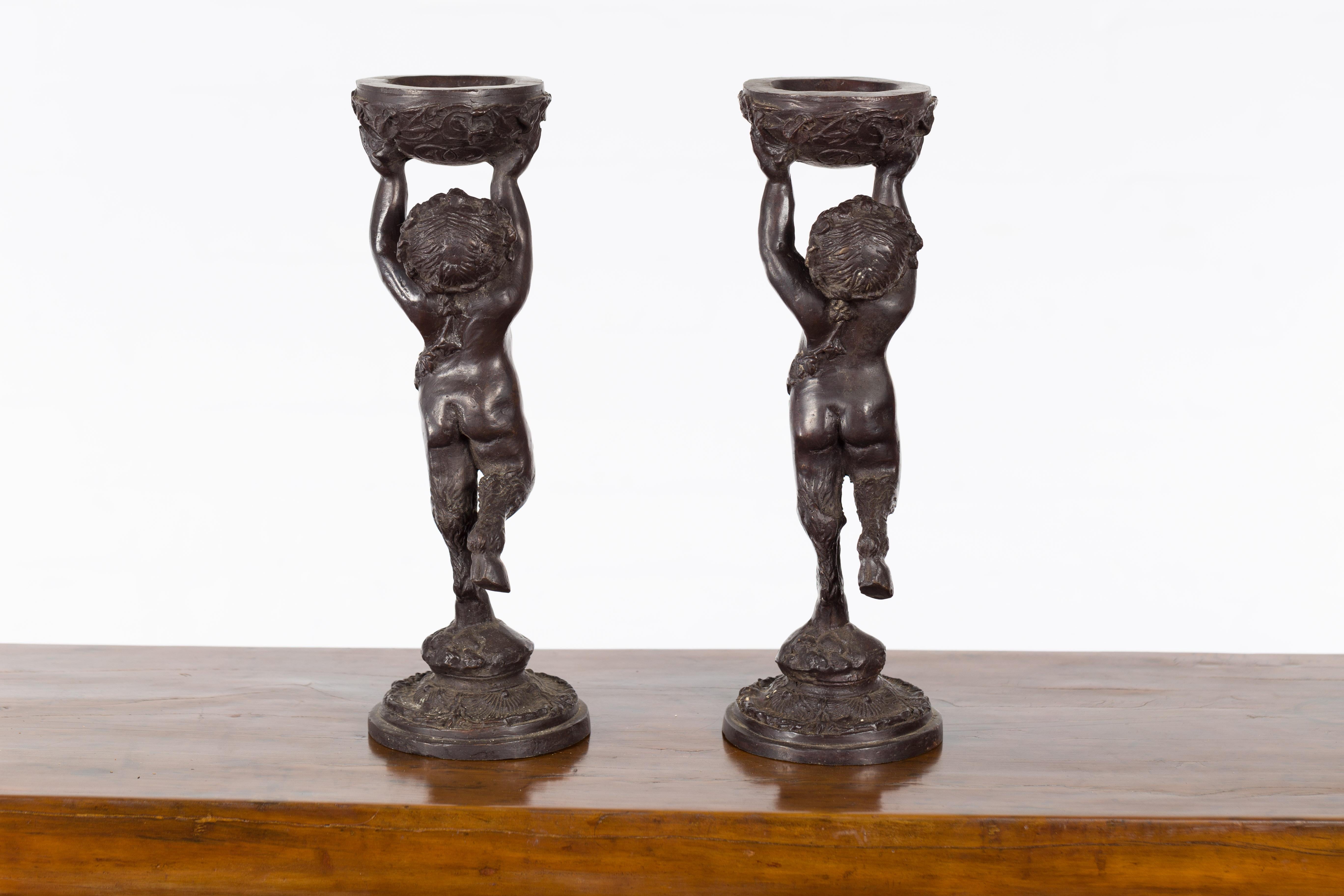 Greco-Roman Style Bronze Candle Holders Depicting Young Satyrs Holding Vessels For Sale 7
