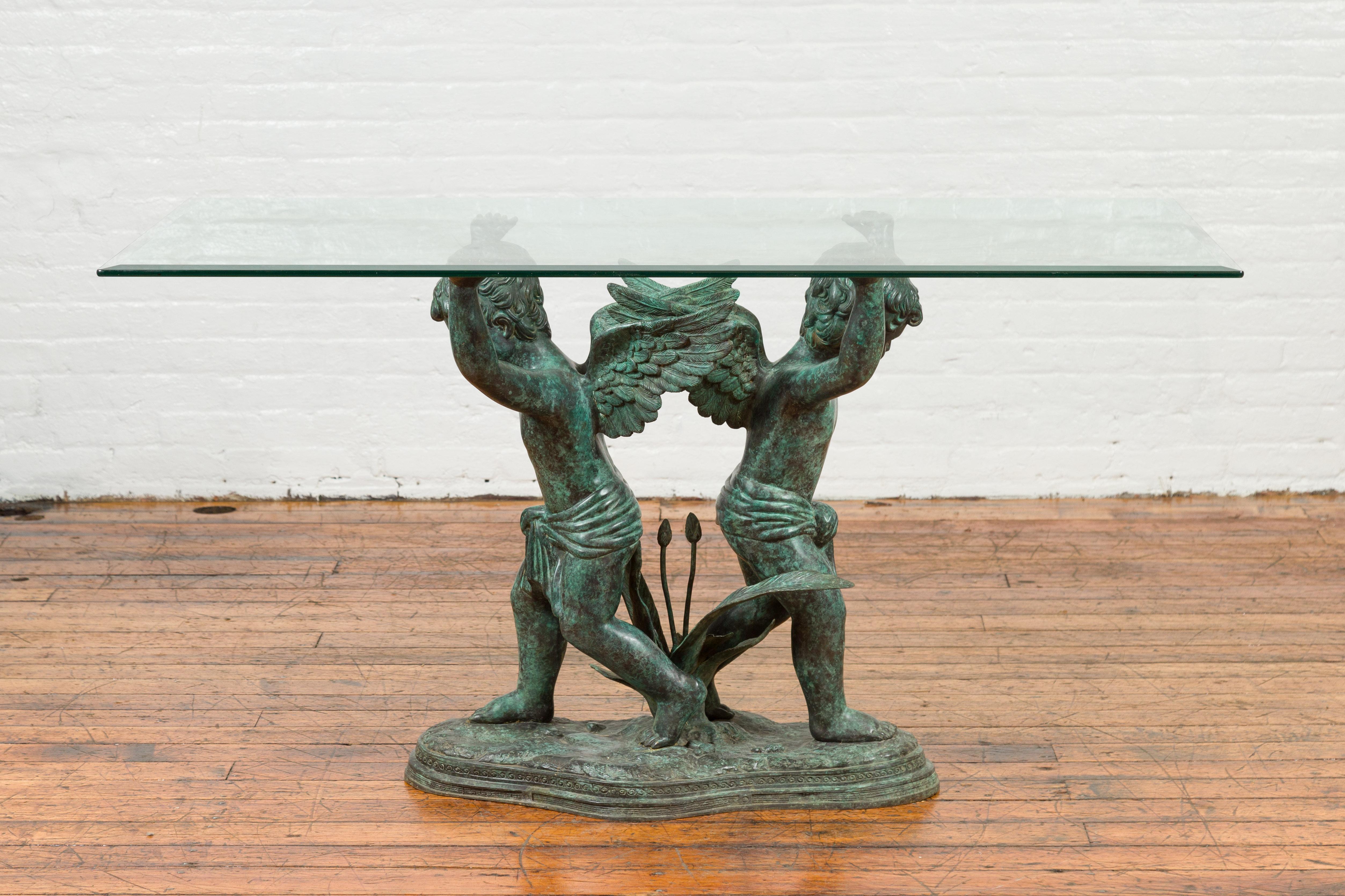 A Greco-Roman style contemporary bronze double cherub dining table base with Verde patina. The top is not included but shown on the photos to allow better visualization of the possibilities. Created with the traditional technique of the lost-wax (à