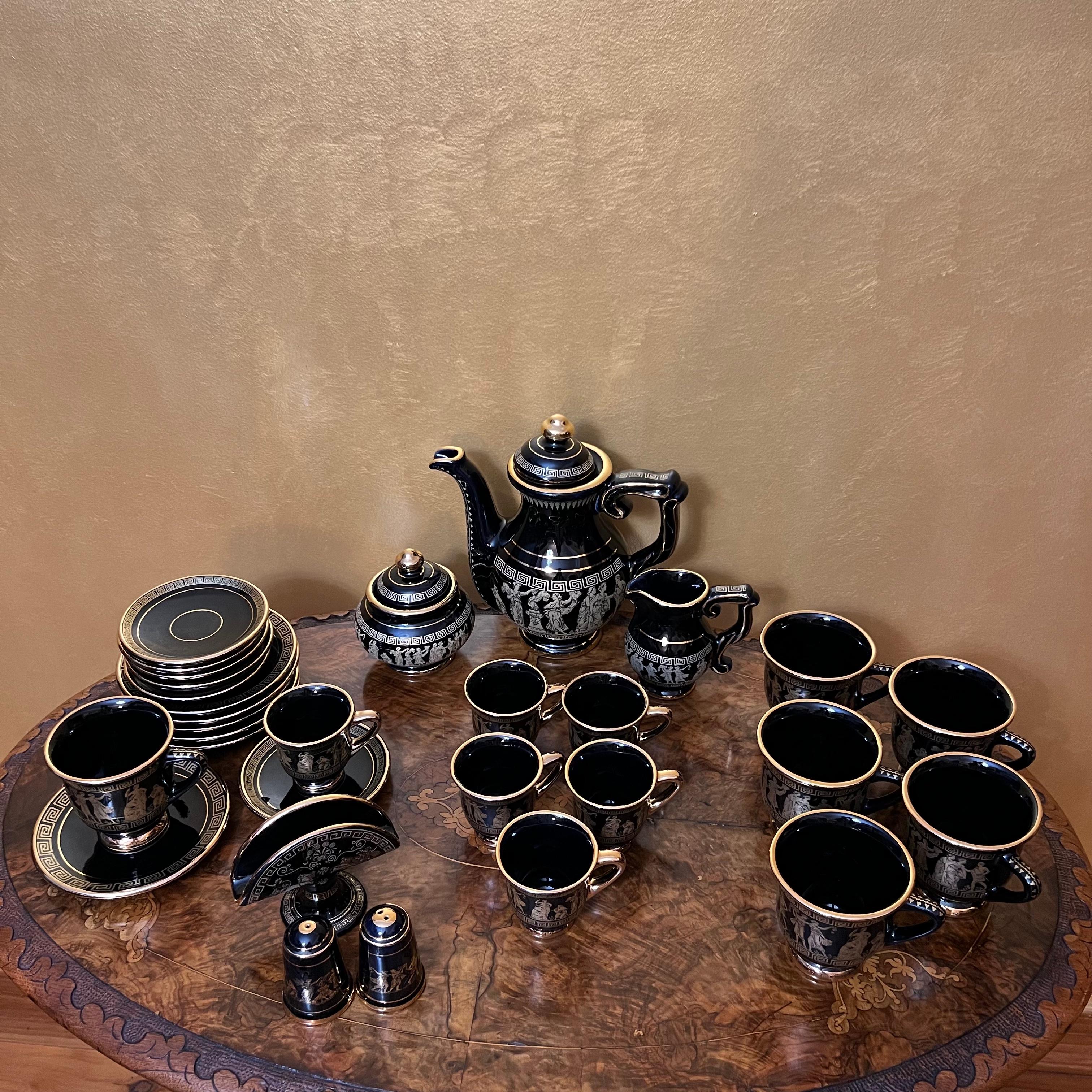 Gold and blue black greek print design, comes with tea pot, milk & sugar, 6 x tea cups & saucer, 6 x coffee cups & saucer, salt & pepper and napkin holder, there are some scratches to parts of the items, such as the spout and mainly in the cups, the