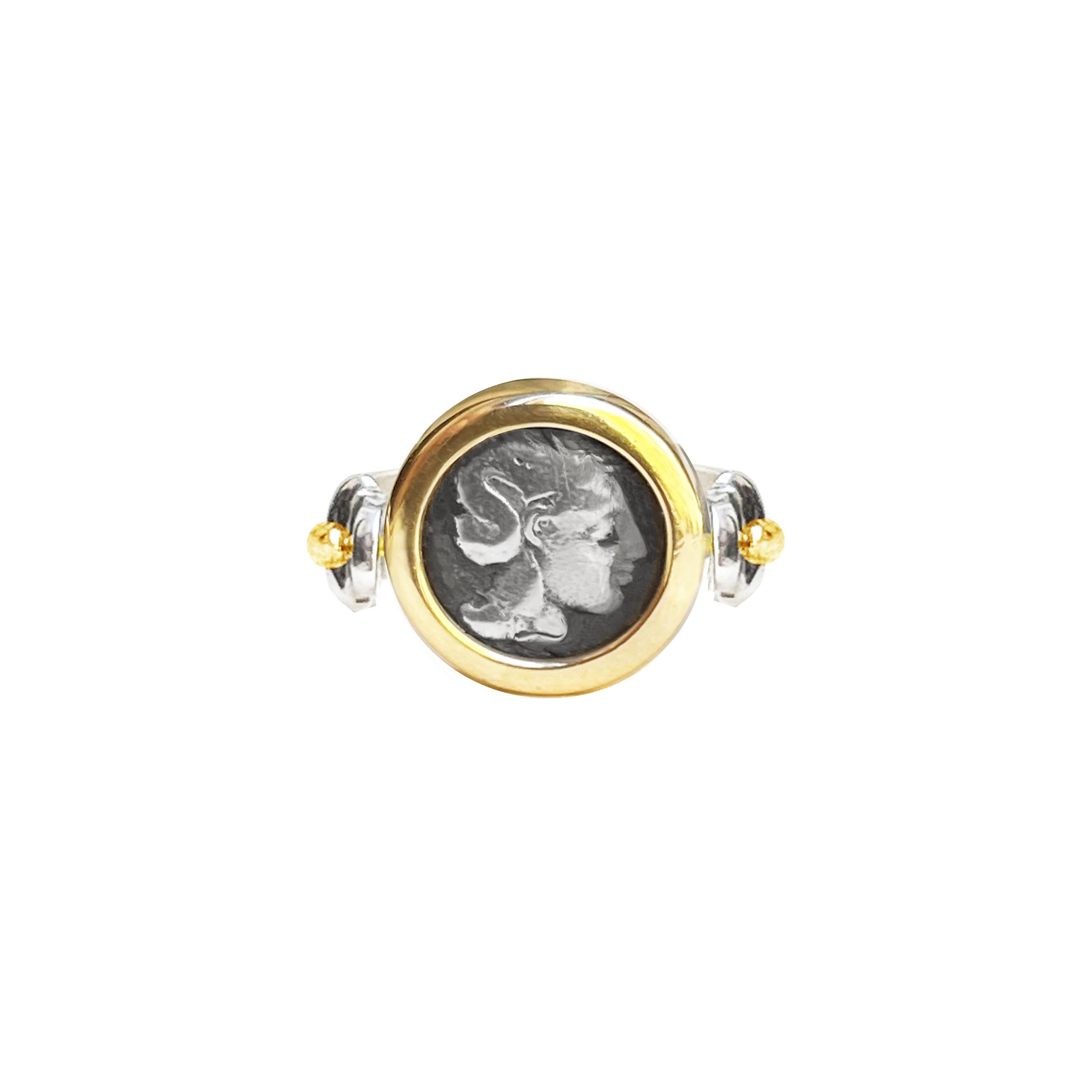 An authentic Greek diobolus dating back to 281 BC, depicting Goddess Athena, has been set in this 18 Kt gold and sterling silver ring; Heracles standing with a lion in the other side of the coin.
Athena is the Olympian goddess of wisdom and war and