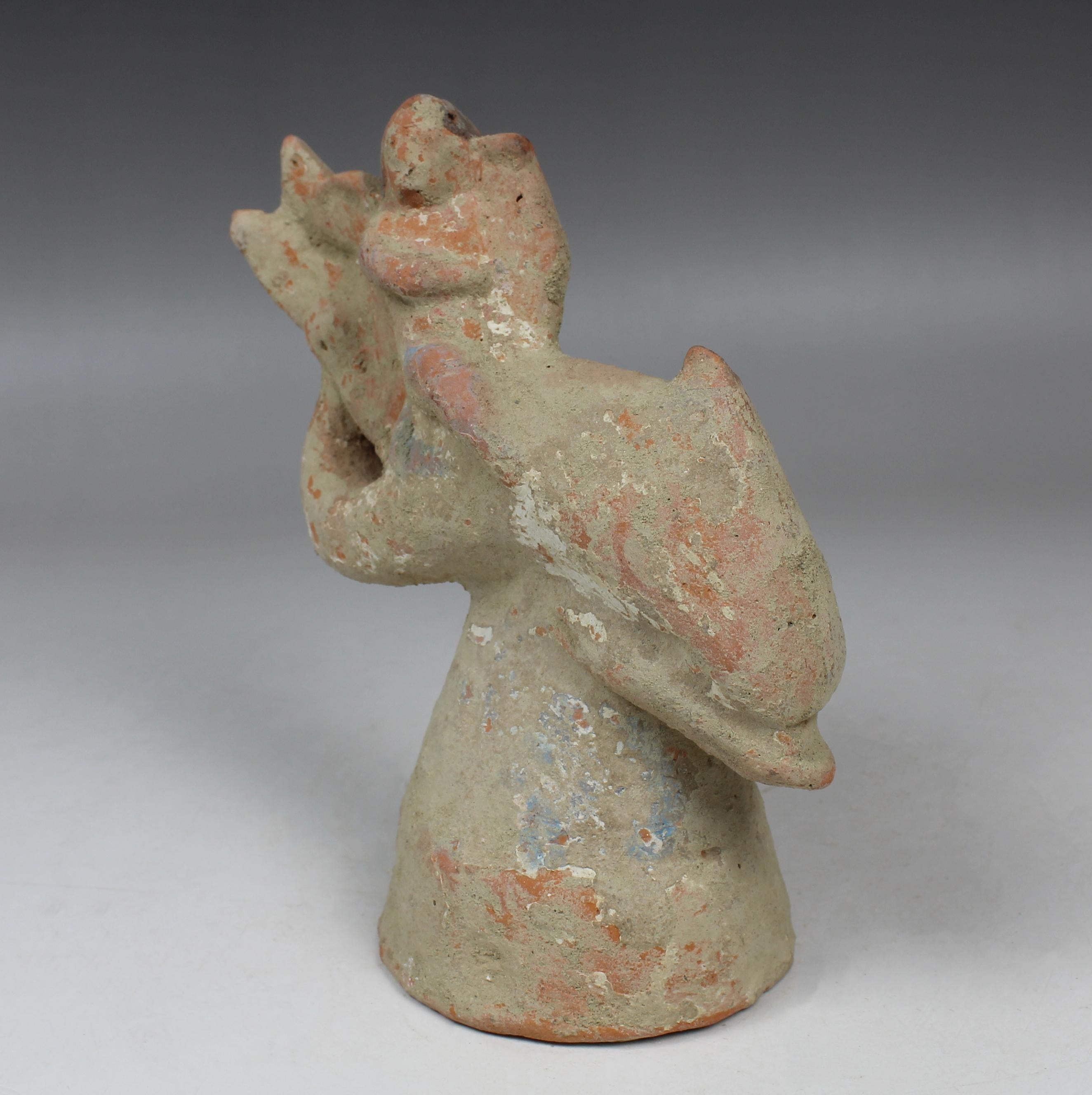 Classical Greek Greek figurine of a little Eros riding on a dolphin, holding a lyre For Sale